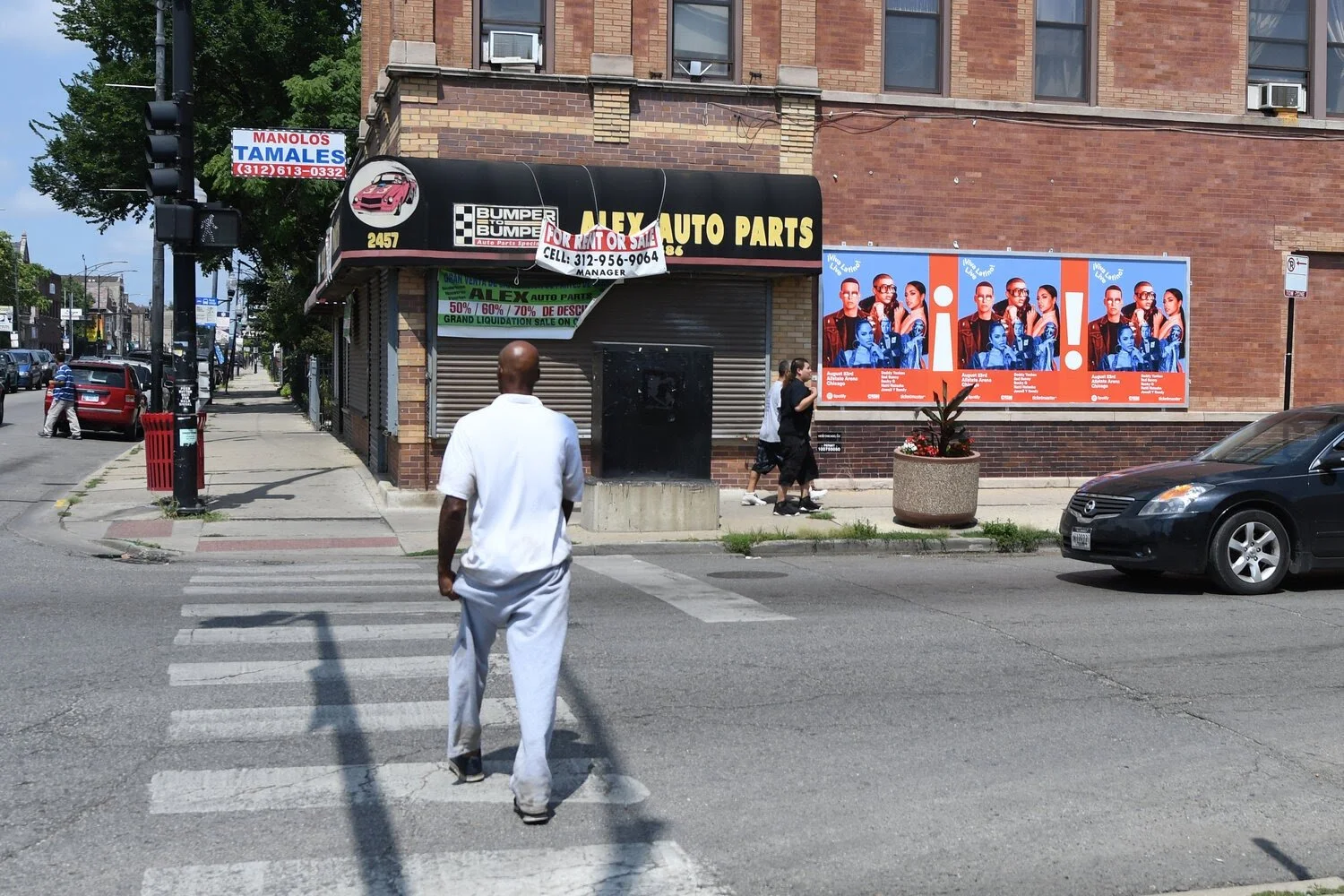 Small business wild posting ads displayed near a Chicago intersection for local outdoor advertising visibility