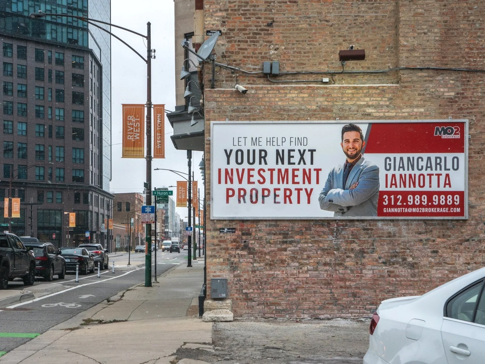 Local real estate billboard ad displayed on a brick building to reach buyers and sellers in a Chicago neighborhood