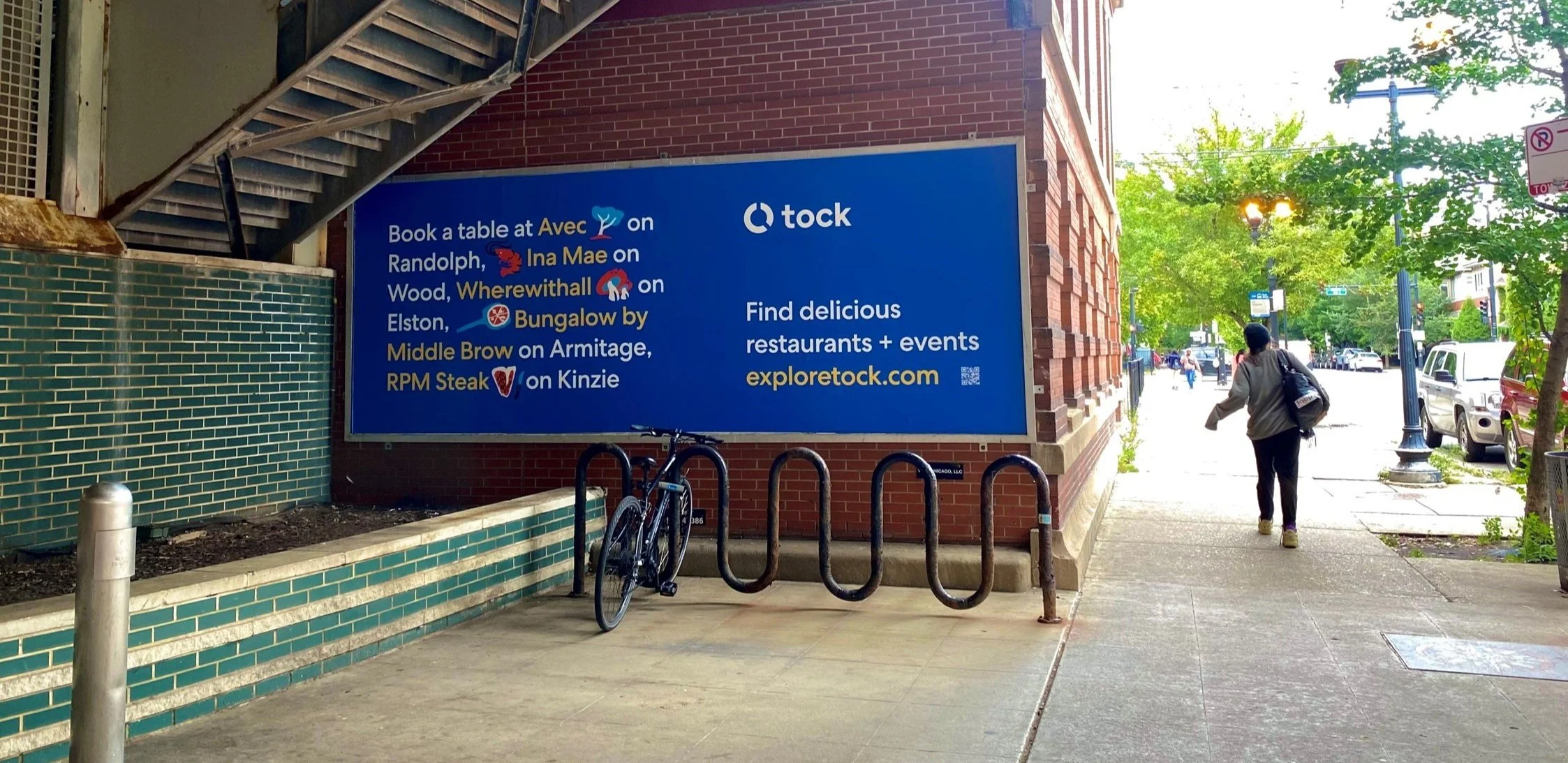 Tock wild posting ad in Chicago displayed at street level near pedestrian traffic and neighborhood businesses
