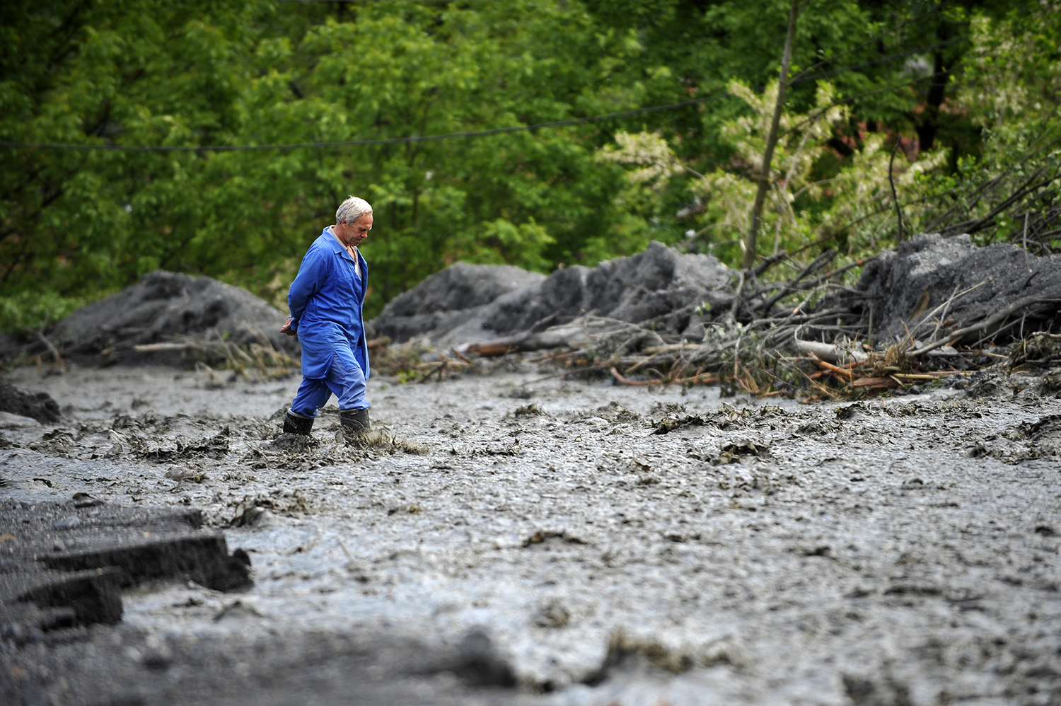 A man passes through the floodwaters area in the village of Topcic Polje, near Zenica.