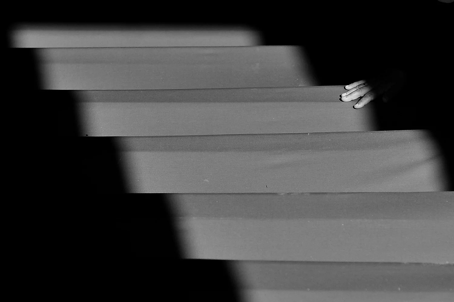 A Bosnian Muslim woman touch the coffin of a relative, 520 newly identified Srebrenica victims are stored in the abandoned hall of a car battery factory in Potocari near Srebrenica.