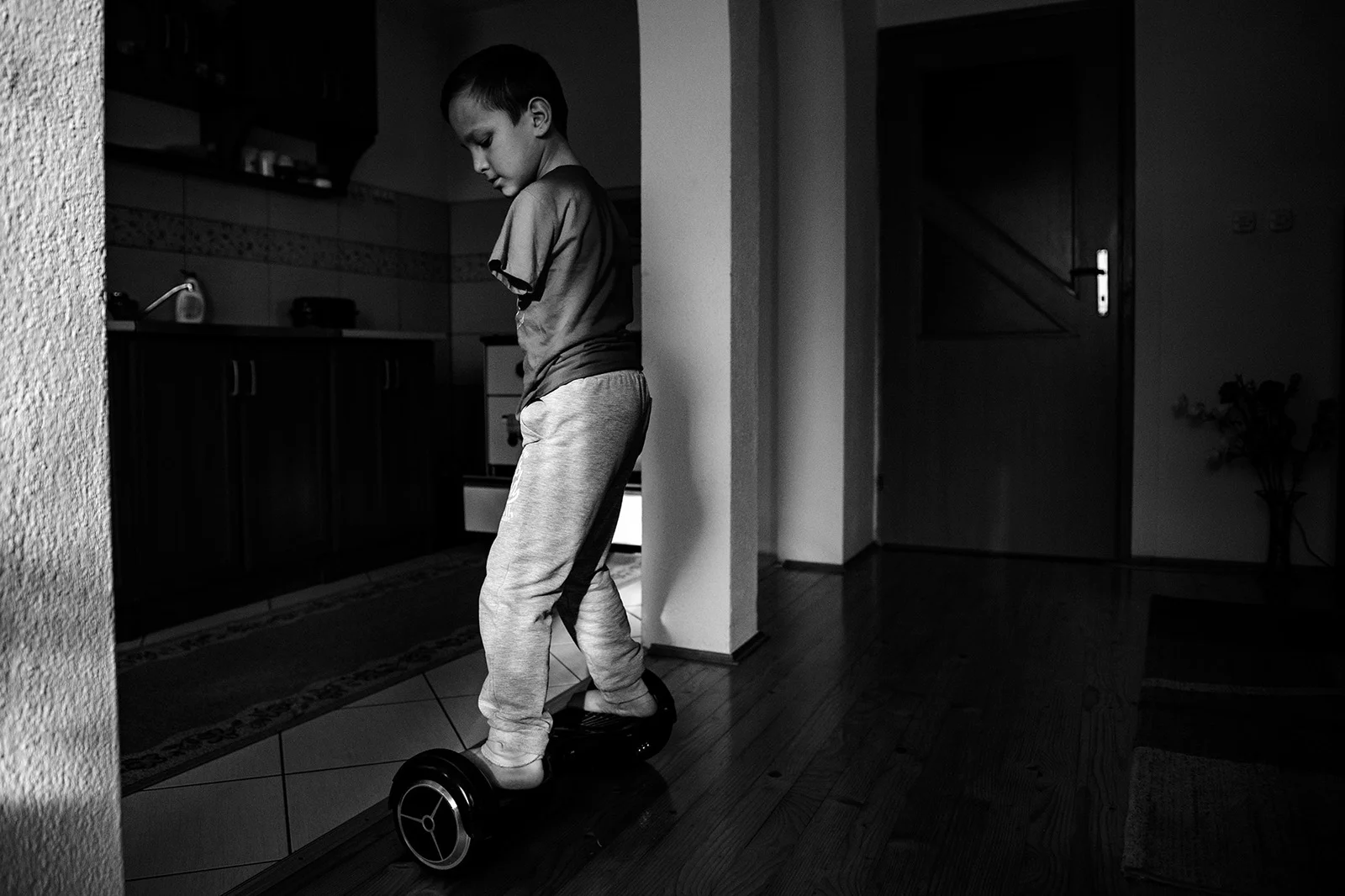 Ismail shows how skillfully he drives a hoverboard in his home in Zenica.
