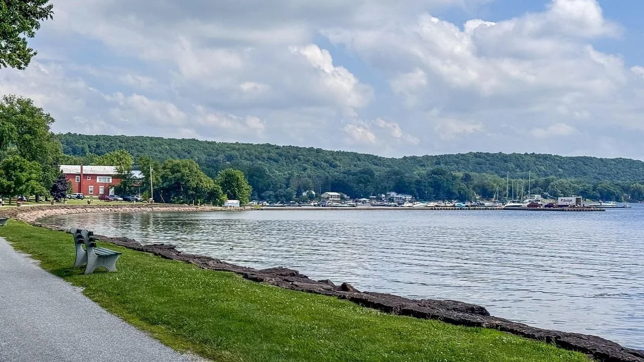 Scenic Champlain Islands waterfront with marina and lakeside pathway.