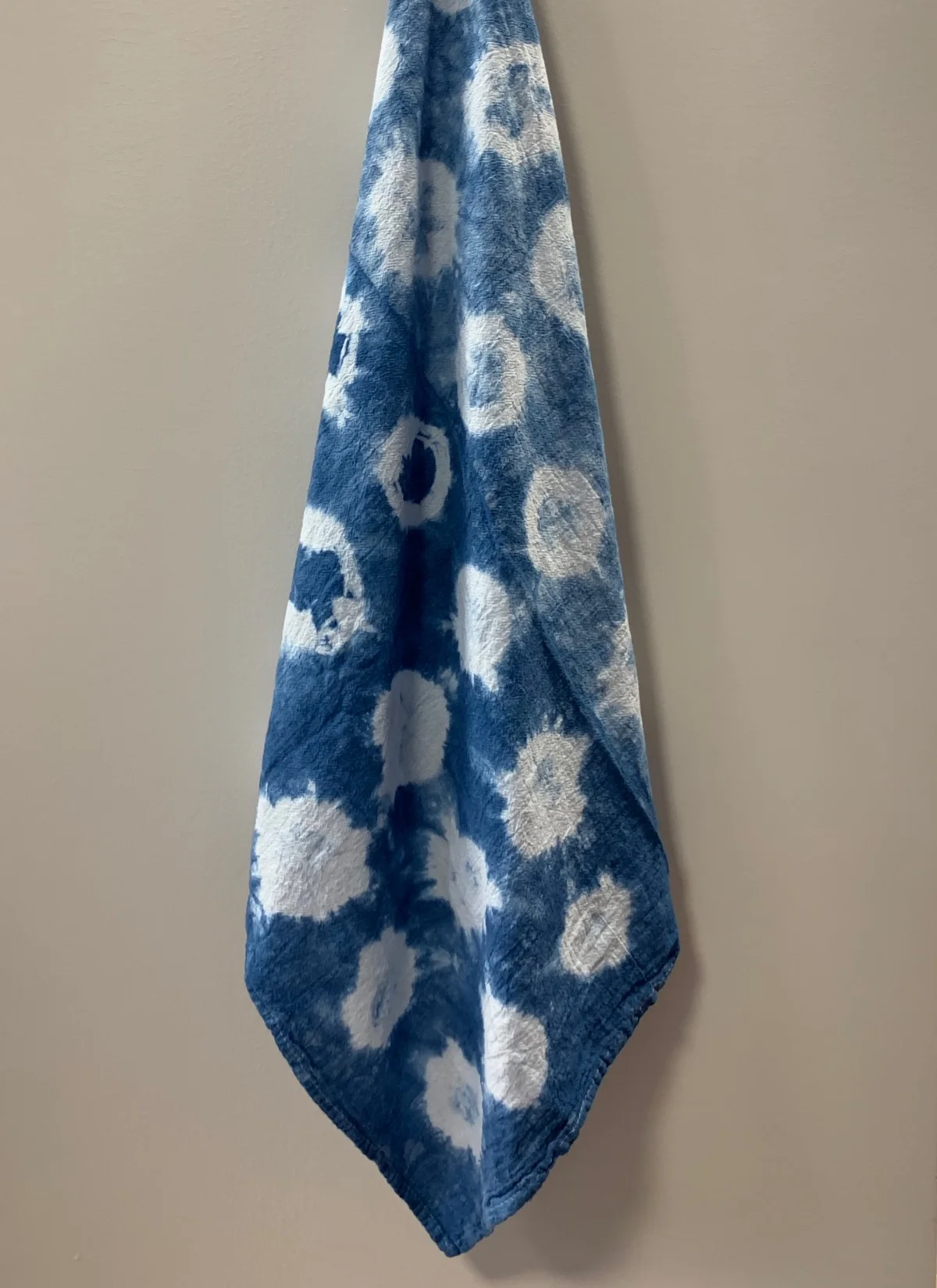 Shibori indigo dyed tea towel made by student in creative aging class .
