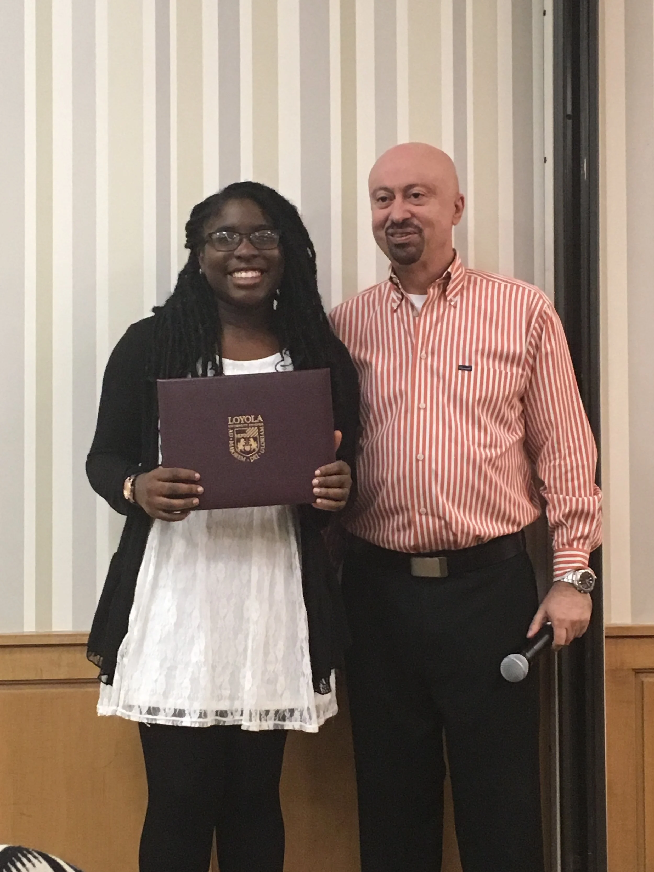  Ademilola Tejuoso being presented with the Cassaretto Scholarship by Department Chair Dr. Duarte Mota de Freitas 