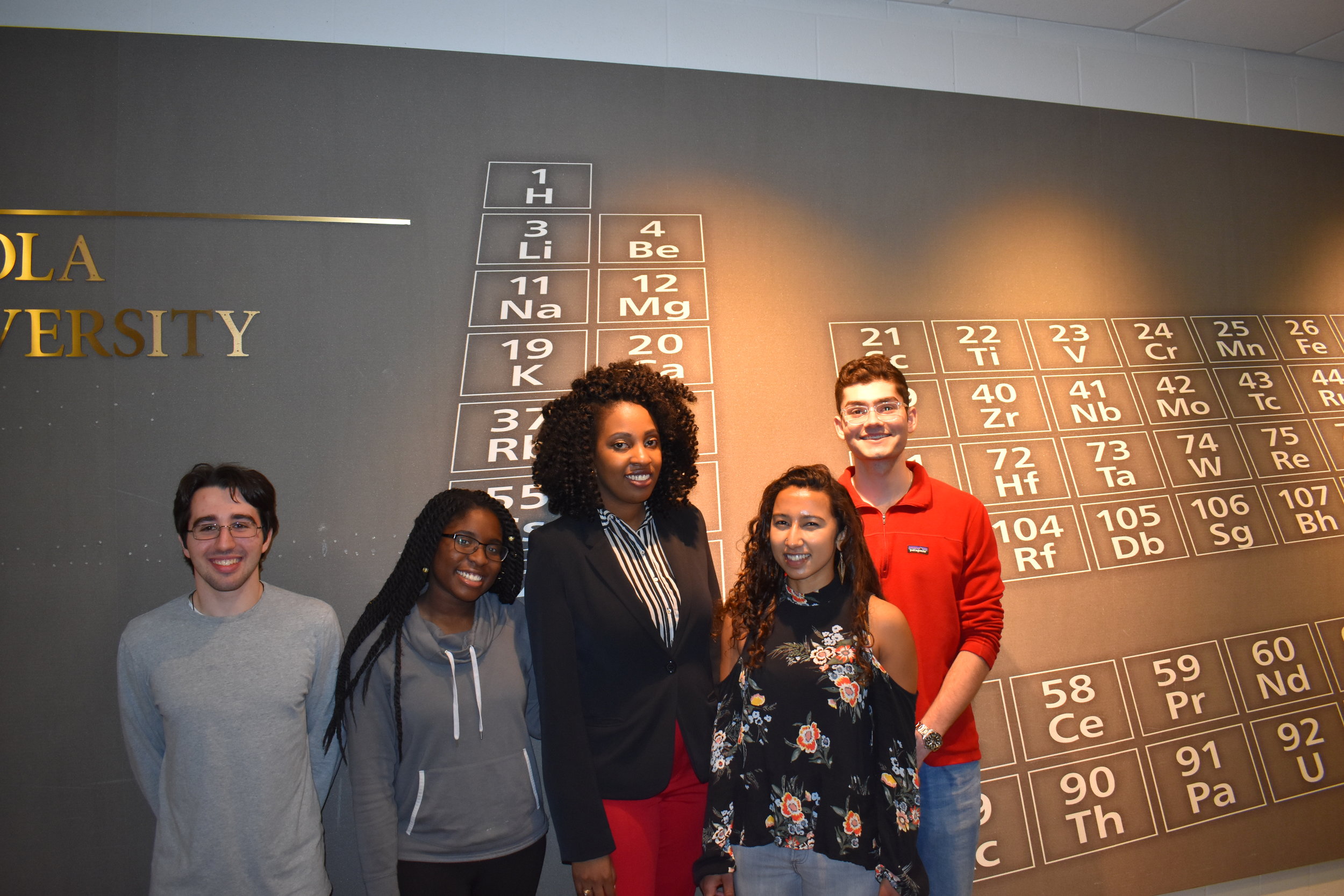  Dr. Heath on the day of her thesis defense (March 27, 2018) with her undergraduates (from left to right): Michael Serwetnyk, Ademilola Tejuoso, Claire Herbert, and Anthony Baroud. 