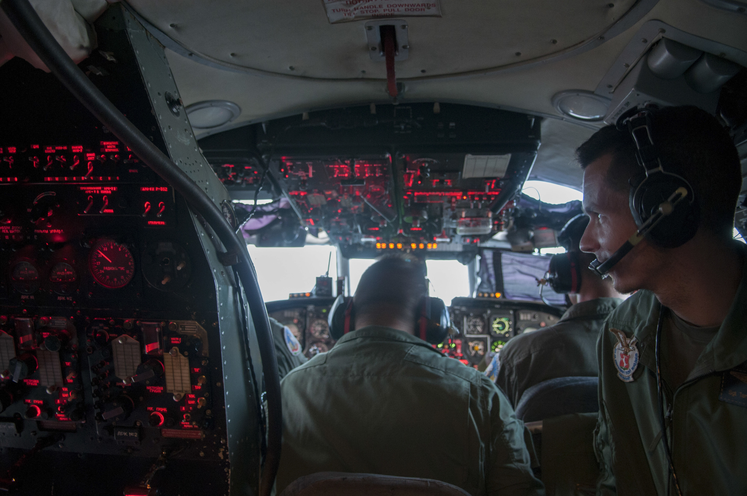 Hungarian Defense Force Lieutenant Tamás Molmòr, sits in the cockpit of an Antonov-26 cargo plane waiting to receieve messages from the control tower before lift-off in Kecskemét, Hungary on June 8, 2015. 