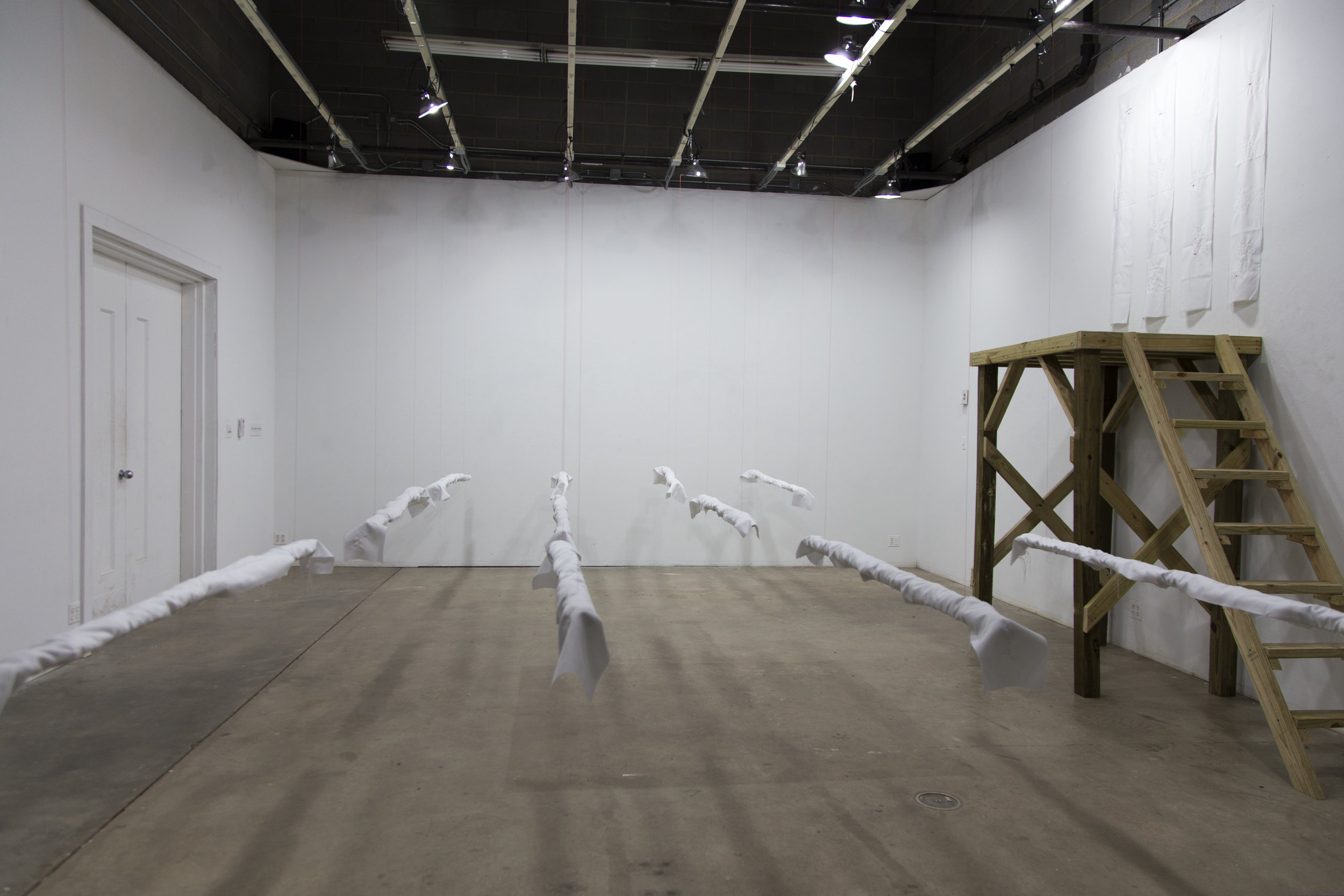 The Owner and The HandWood platform, fabric, embroidered text. 2017