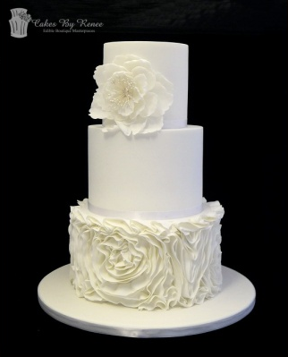 3 tier white wedding cake ruffles frills rosettes