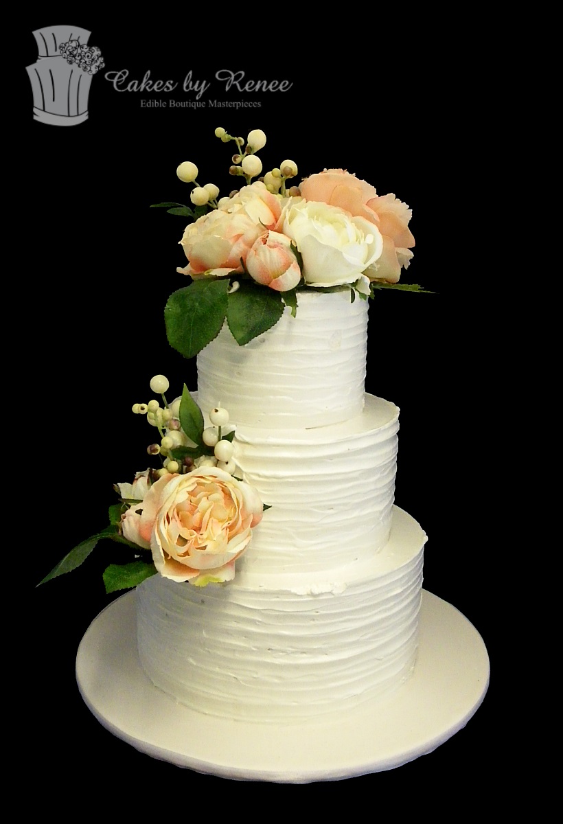 3 tier white wedding cake textured finish fresh flowers