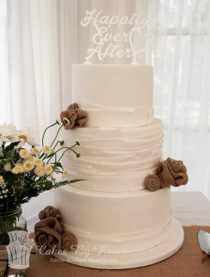 3 tier white wedding cake modern ruffles hessian flowers