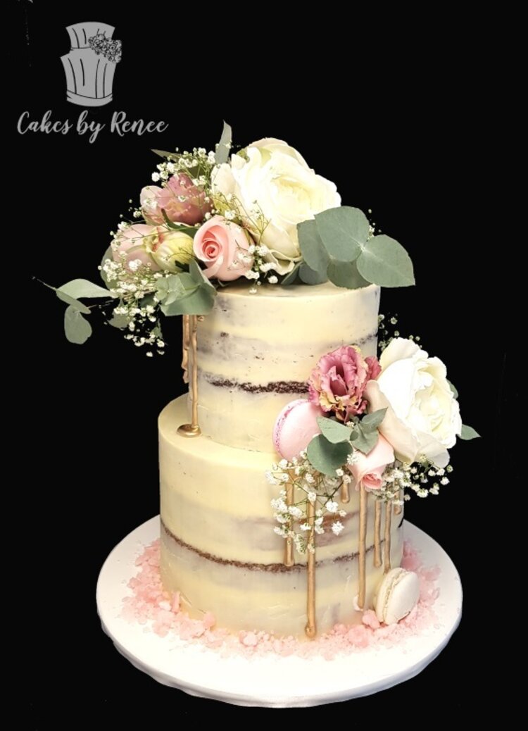 2 tier pastel semi naked wedding cake fresh flowers gold pink