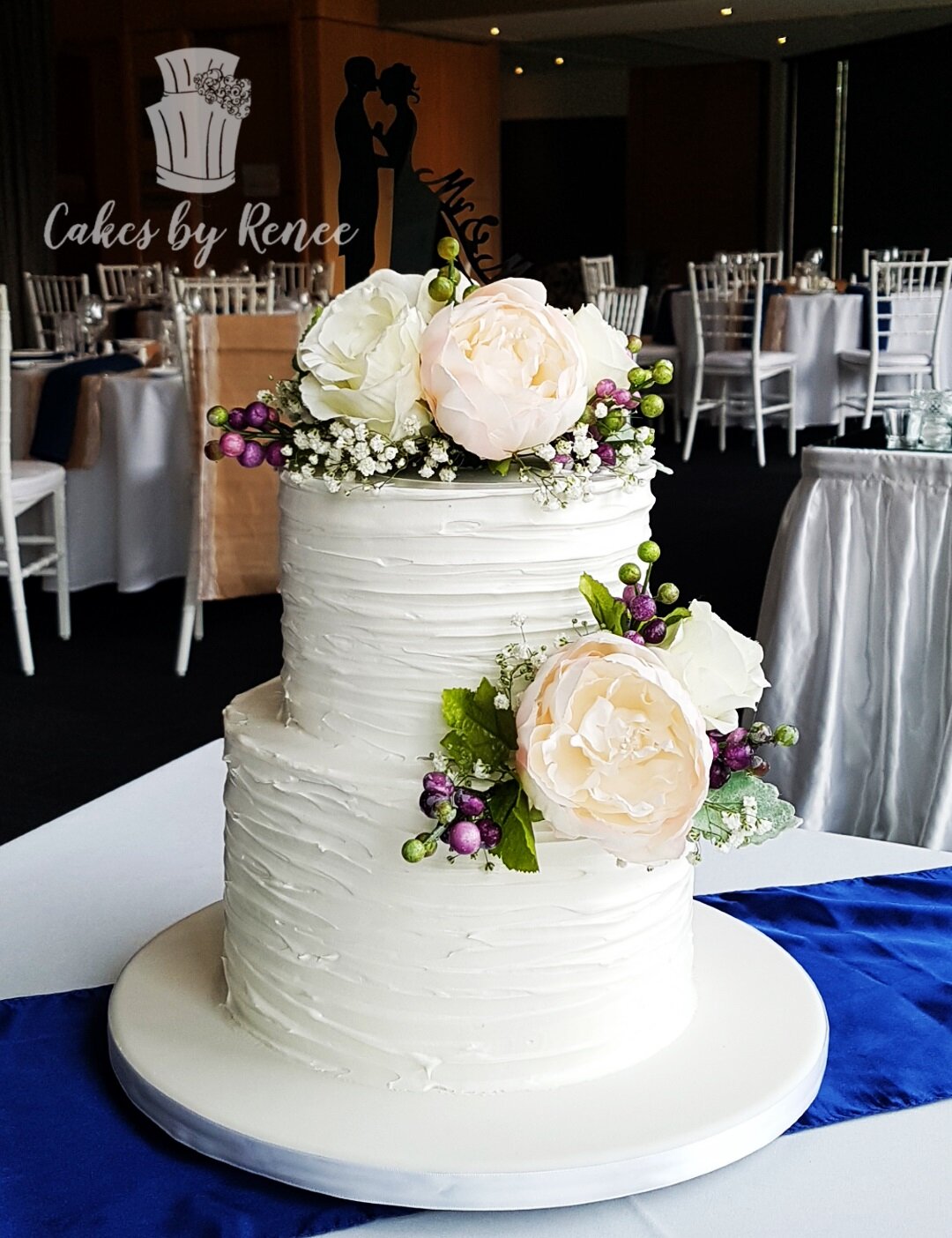 2 tier white wedding cake buttercream textured fresh flowers