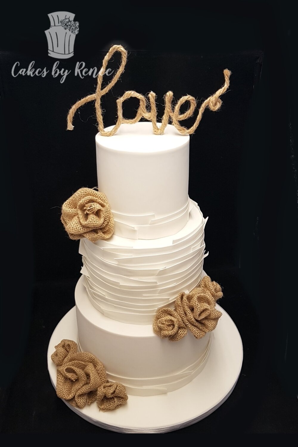 3 tier white wedding cake ruffles hessian burlap flowers