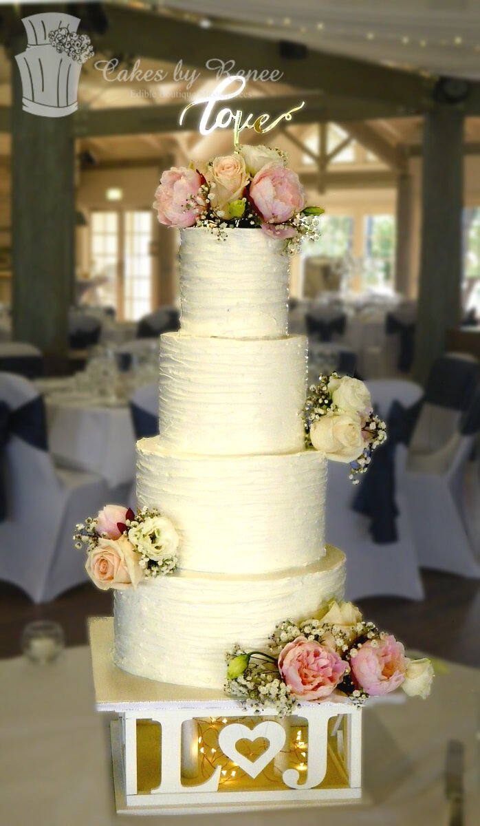 4 tier buttercream wedding cake fresh flowers custom topper