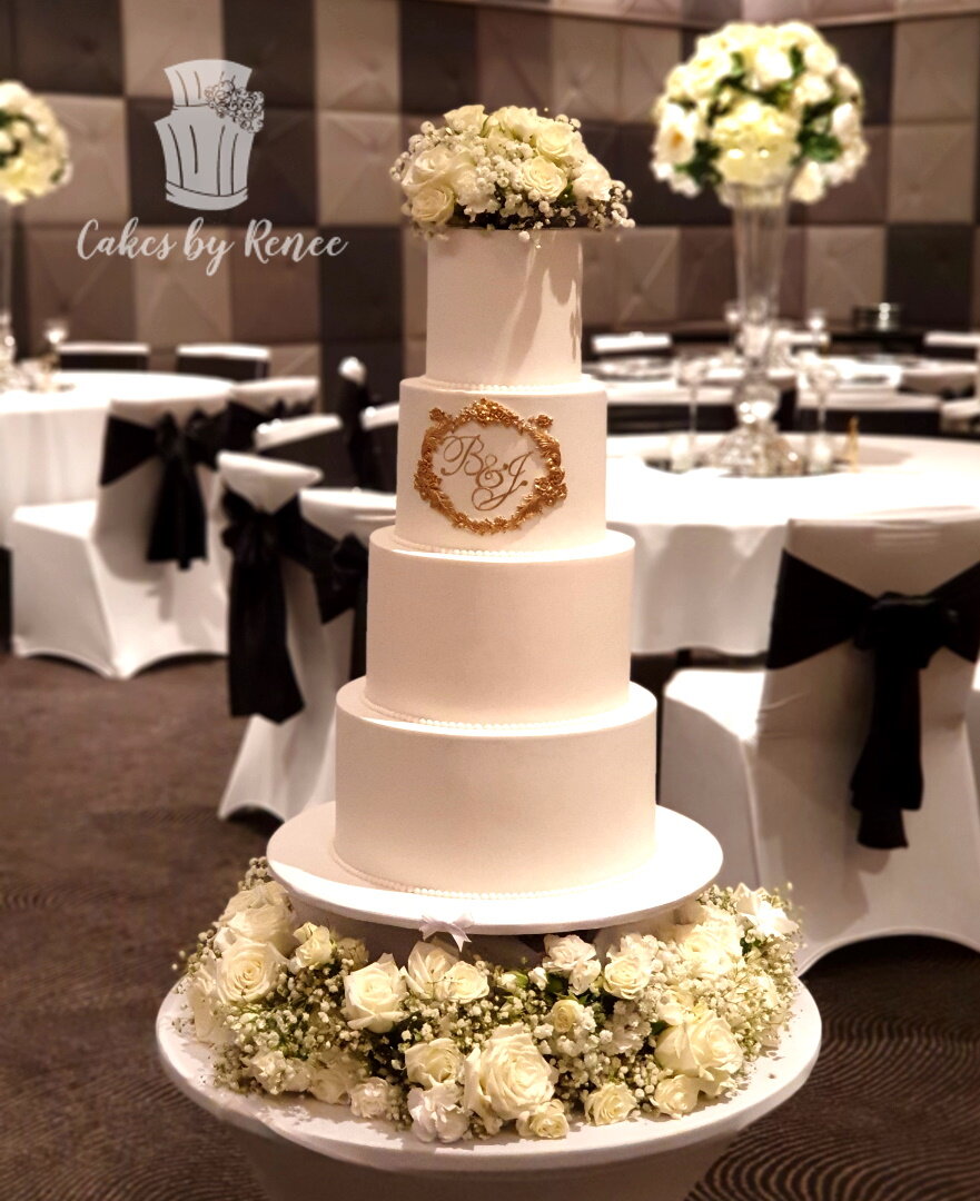 4 tier white wedding cake custom monogram flower base ring