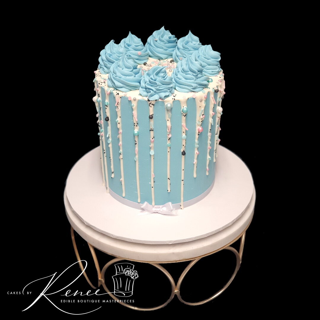blue white drip cake with sprinkles