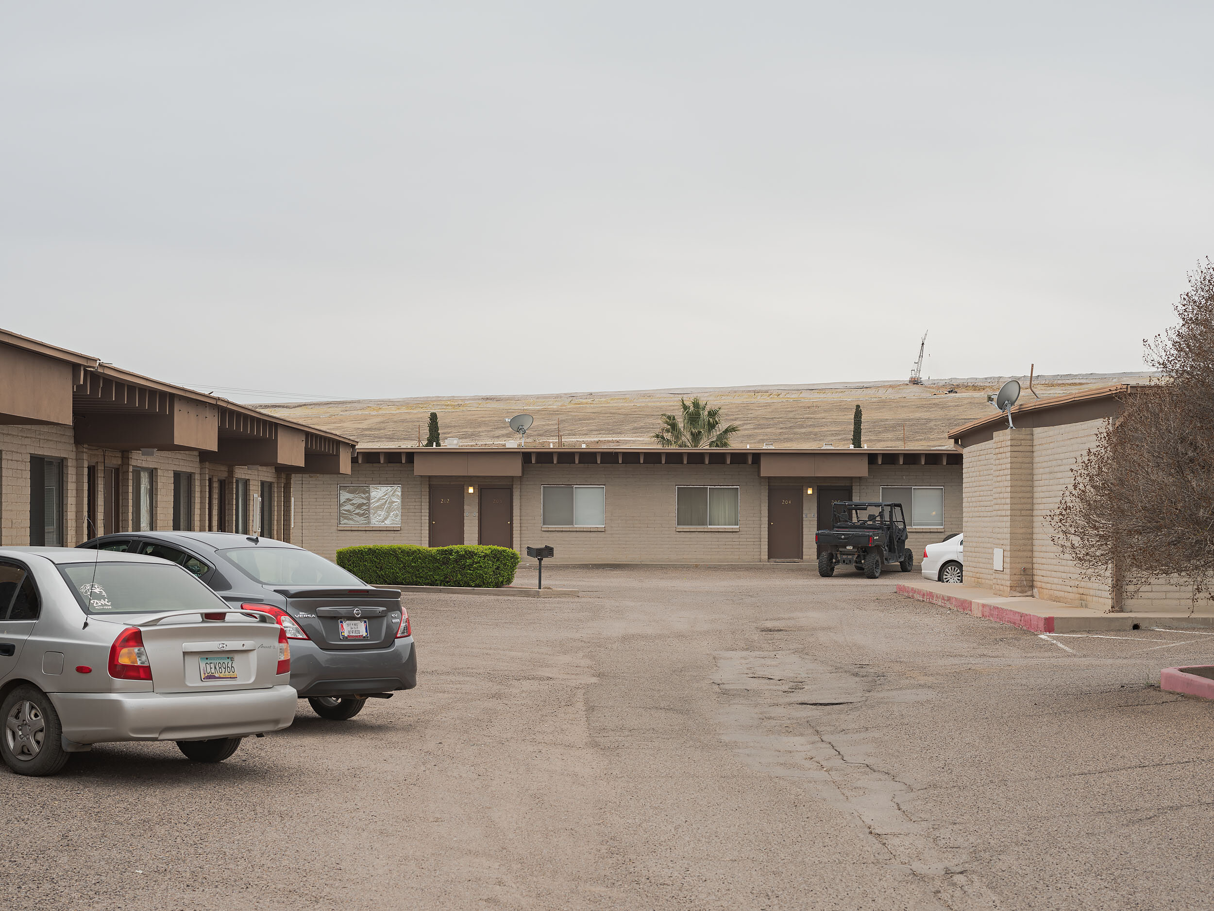 Longfellow Apartments appear to be studio apartments to house workers without families. Morenci mine tailings visible in the background.