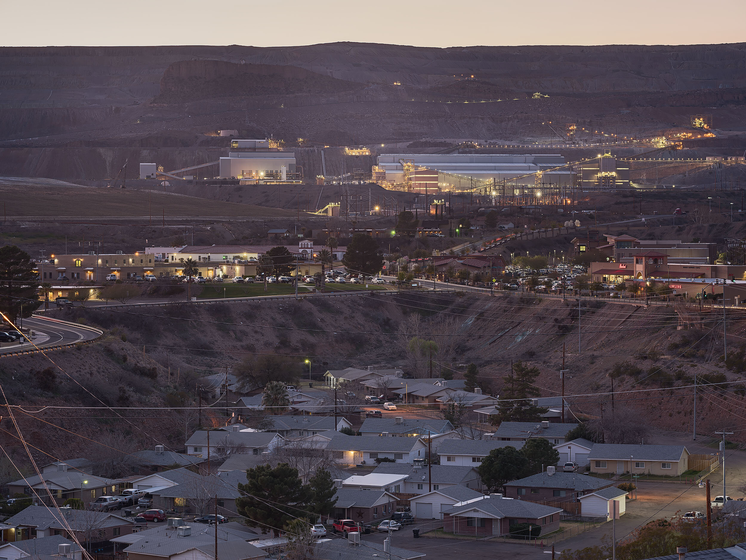  Morenci layers. Mine operations on top. Commercial sector with a supermarket, motel, and bowling alley in the middle. "Down in the hole" section of Freeport-McMoran Morenci Housing below.  