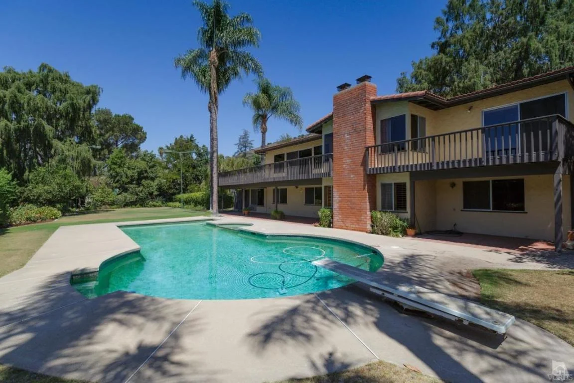 Entertainer's Delight! This home was built in 1969 by the Morris family from William L Morris Chevrolet. Located on a private drive the property features approximately 3,464 square feet with 4 bedrooms, 5th bedroom or office, separate guest quarters, 4 1/2 baths, on two separate parcels totaling over an acre. Open and spacious floor plan. Upper level features the kitchen with separate wet bar which opens to family room, formal dining room, living room with fireplace, master bedroom with 2 closets, vanity area and bathroom, plus attached office/bedroom. Expansive outdoor deck off of the family room, kitchen, and master which overlooks the yard and is great for entertaining. Downstairs has an additional 3 bedrooms, 2 baths, and separate living area with fireplace. Separate entrance guest qua