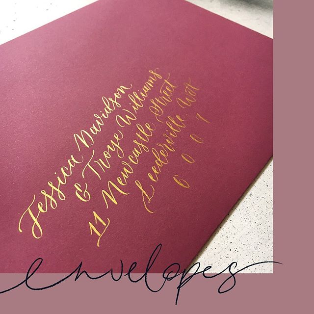 Gold calligraphy addresses on burgundy envelopes ✨