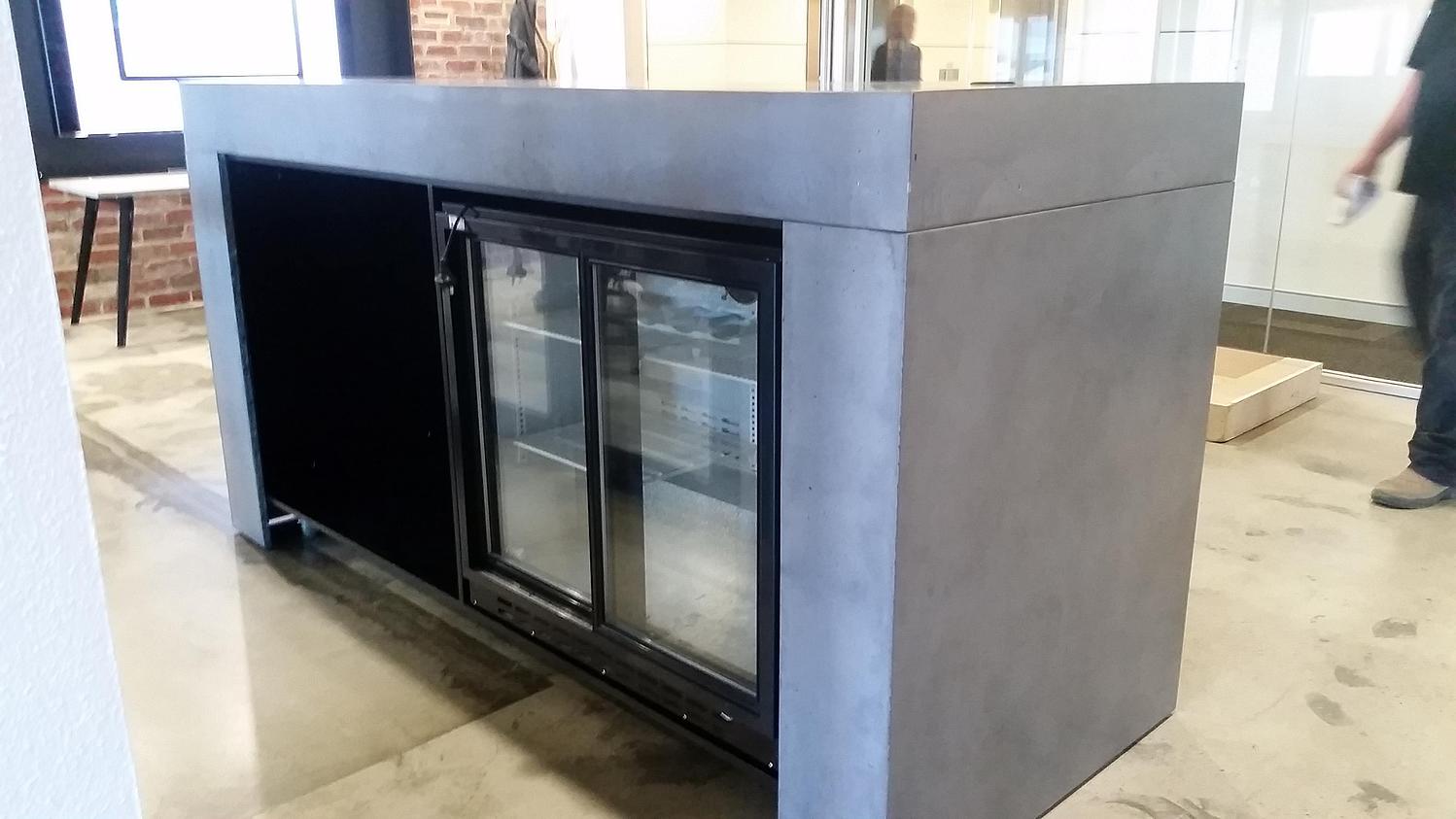 concrete reception benchtop with fridge