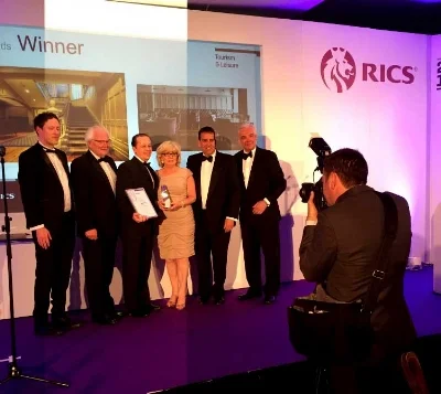 From left David Snodgrass, Noel James & Karl Pedersen (Mullarkey Pedersen Architects) & Helen Quigley (Inner City Trust) accepting the award in Belfast last Thursday evening with broadcaster Paul Clark. 