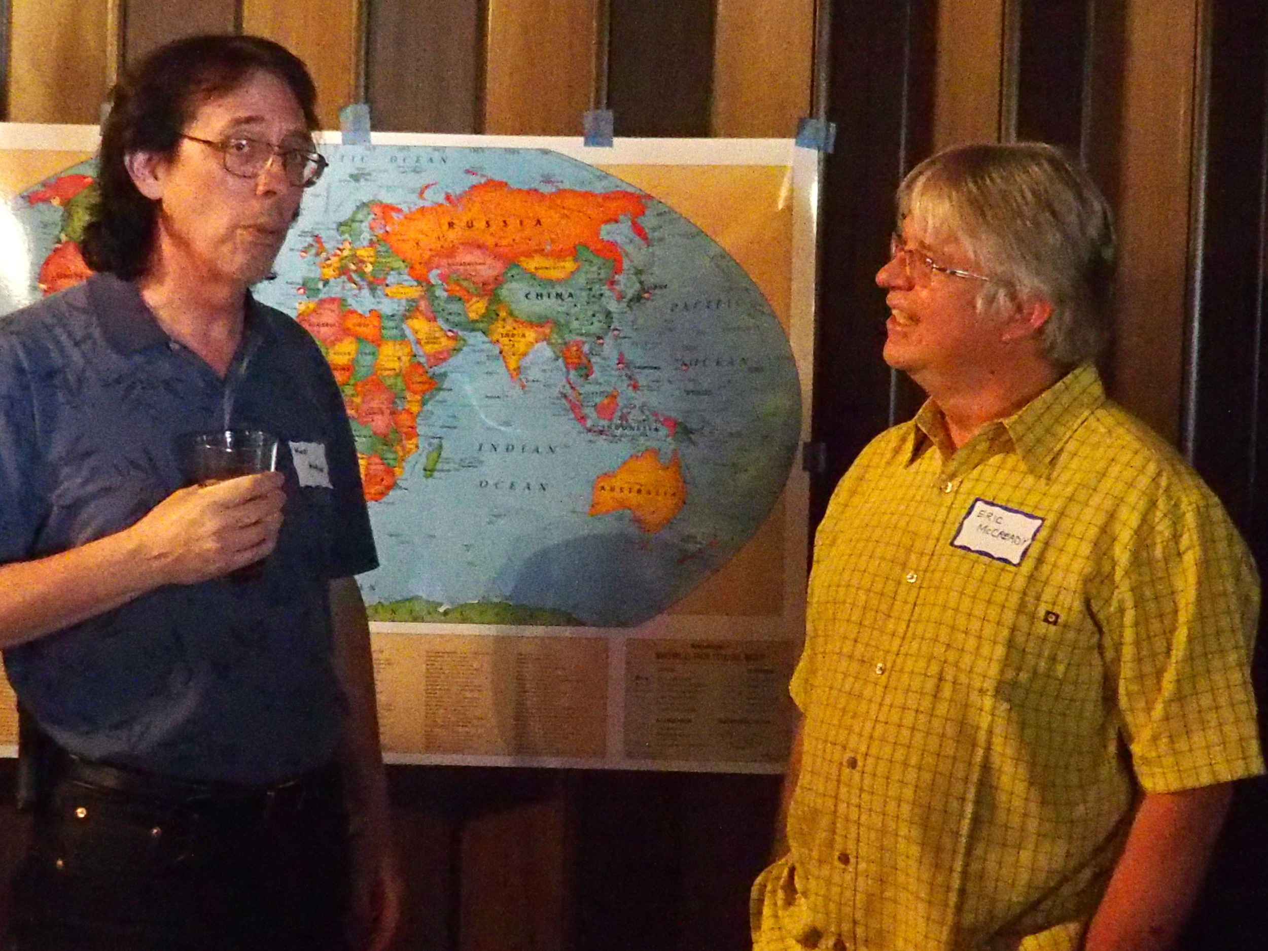 Ken Althiser and Eric McCready in front of the world map.