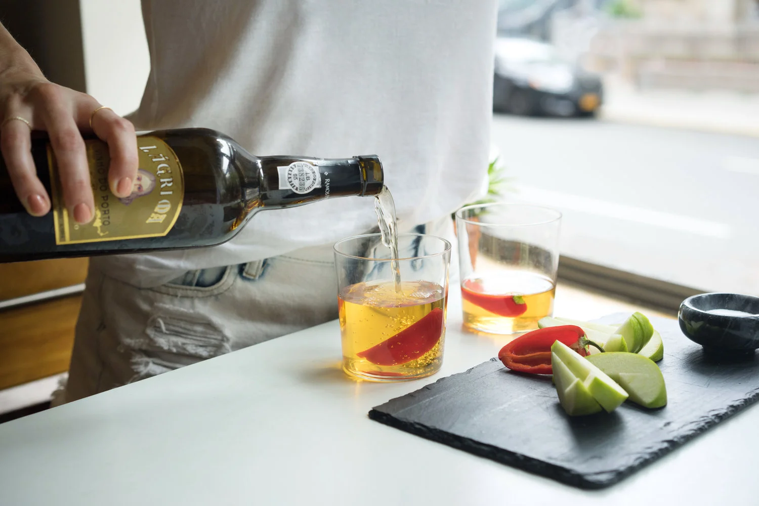 Pouring a glass of wine with fruit