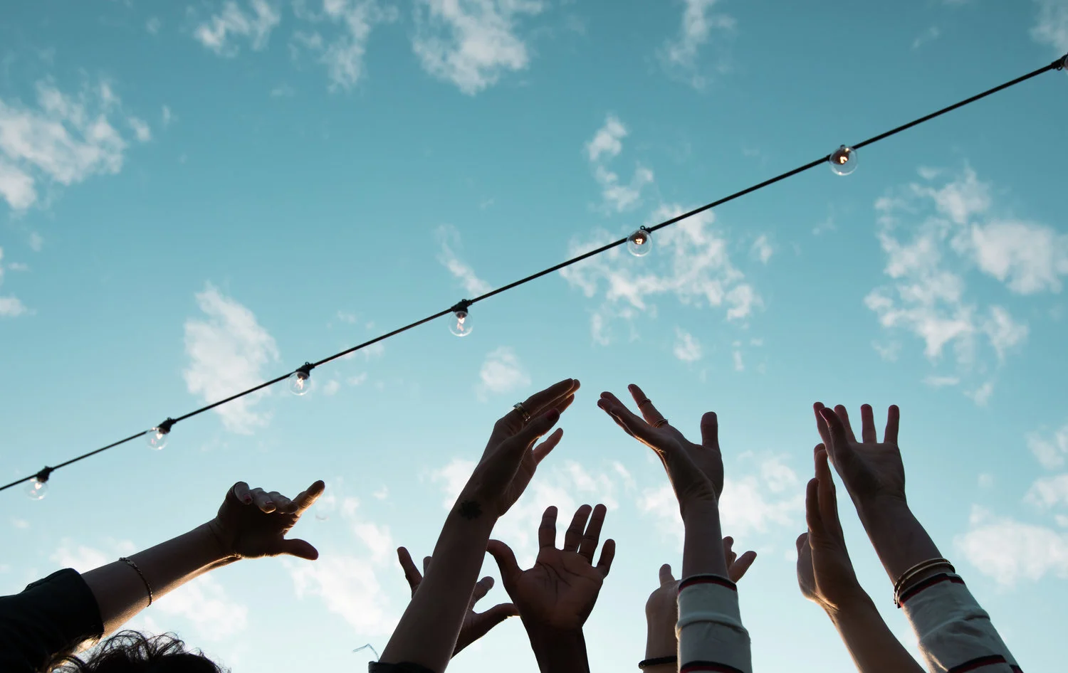 Hands in the air with blue sky