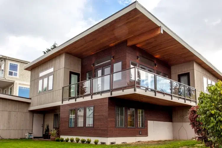 modern-two-story-home-cedar-siding-glass-balcony.webp.webp