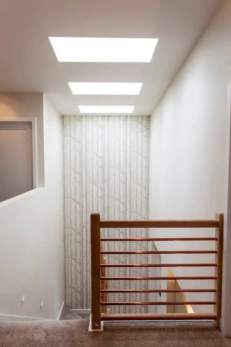 stairwell-skylights-birch-wallpaper-copper-railing.webp.webp