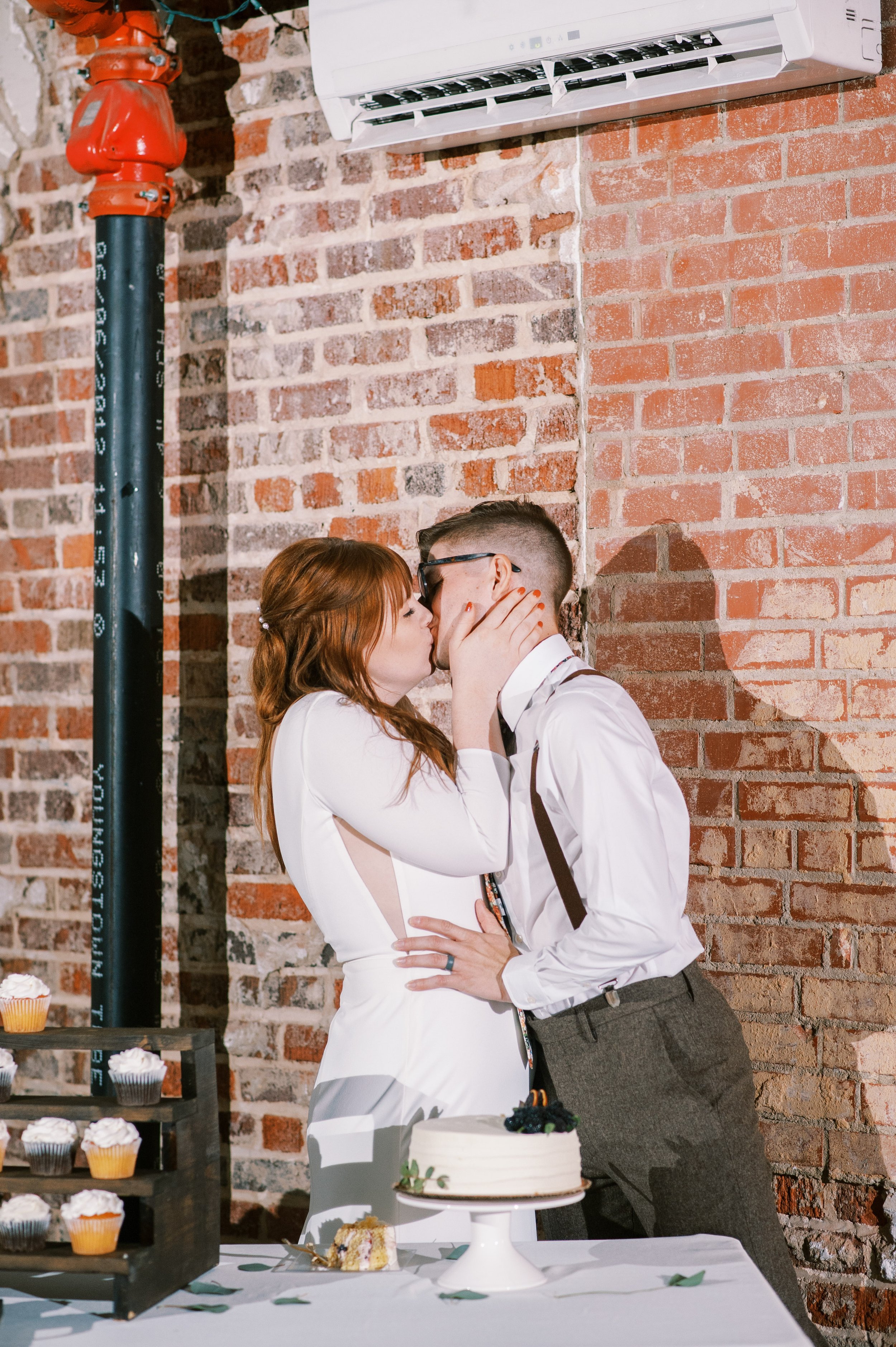 Bride and Groom Kiss Cake Wedding at The Bottle Factory Monroe NC Fancy This Photography