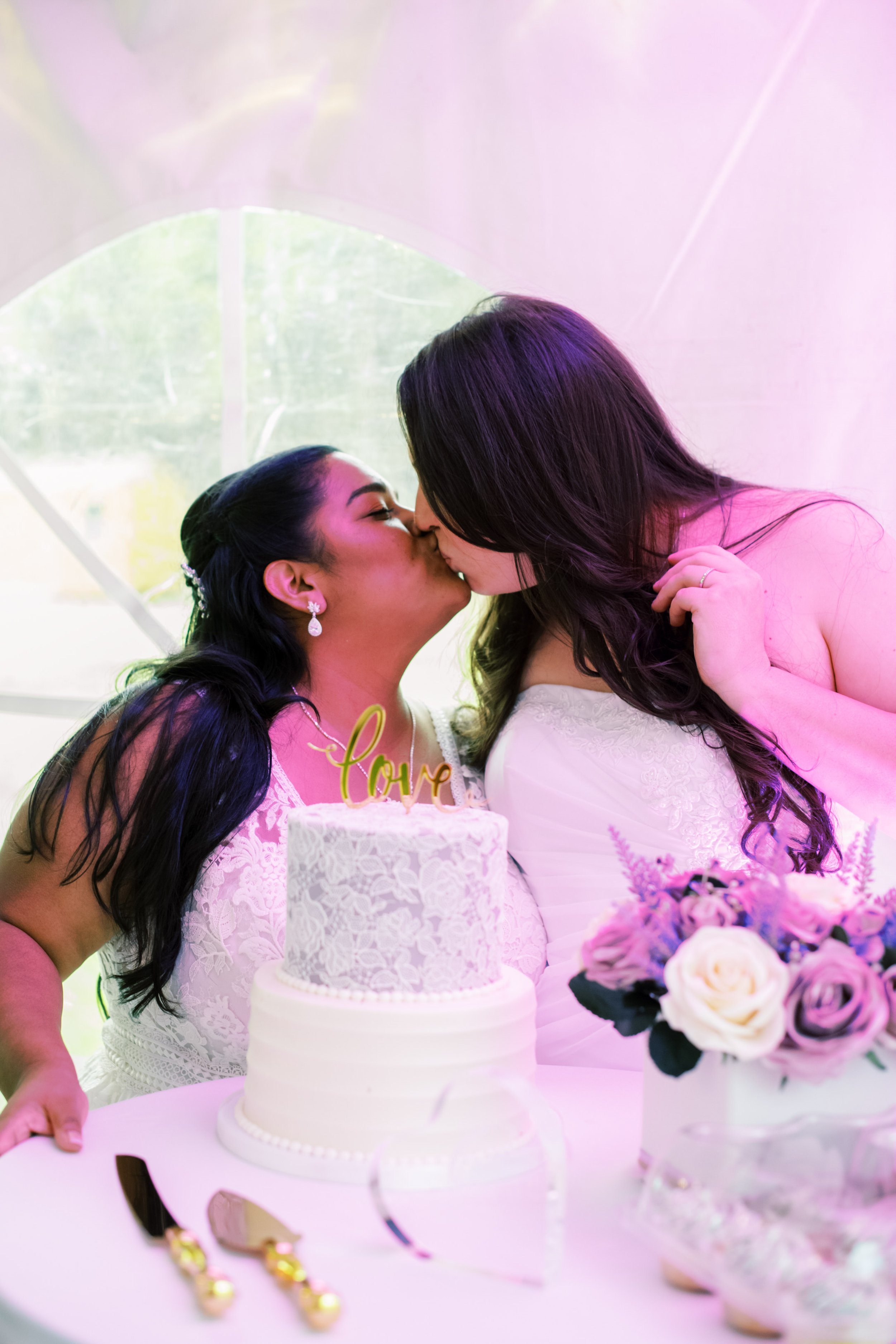Brides with Wedding Cake Kiss Beautiful Mebane NC Wedding in Family's Backyard Fancy This Photography
