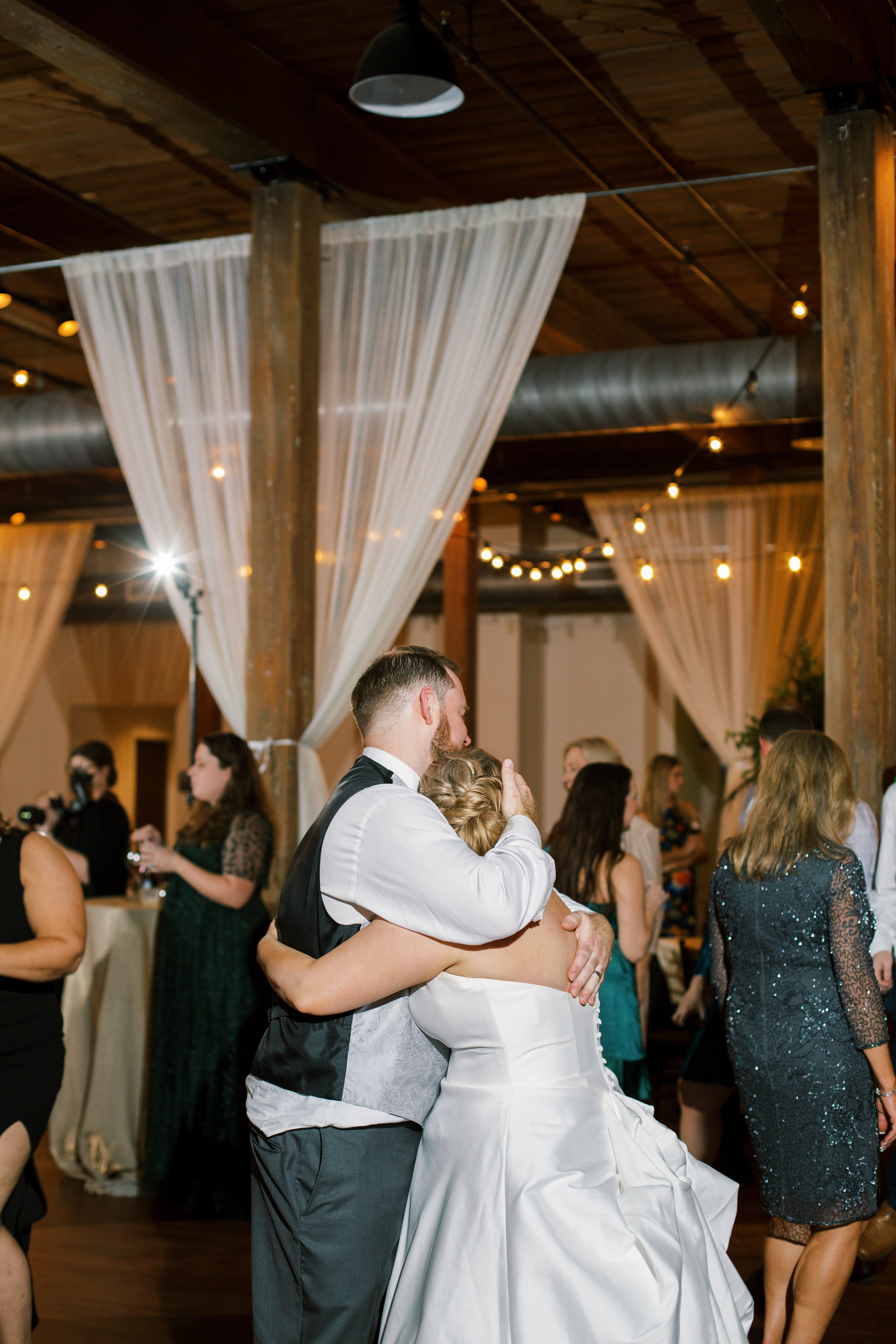 Bride and Groom Hug on Dance Floor Wedding at The Cloth Mill at Eno River&nbsp;Fancy This Photography