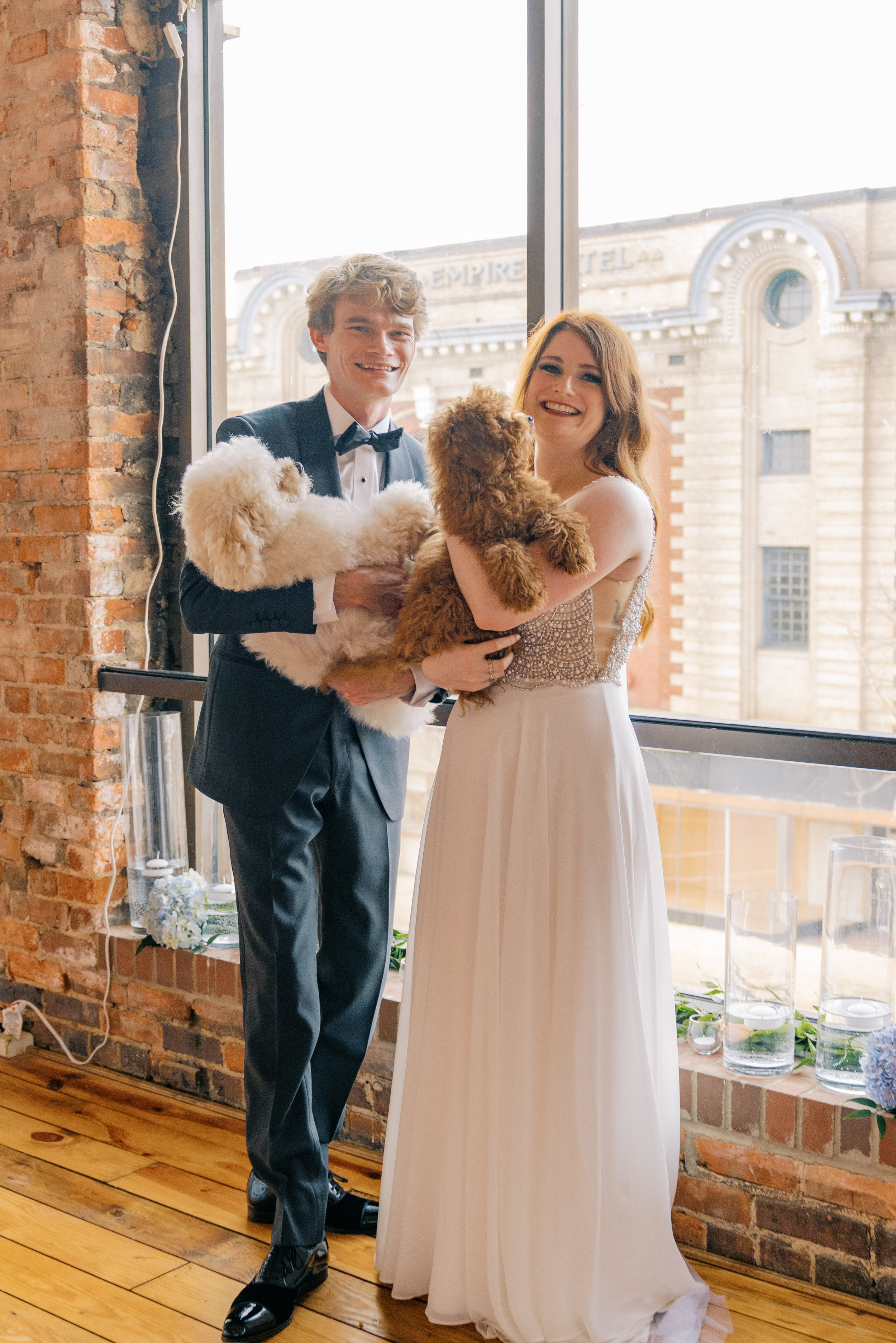 Couple with Puppies in Window Salisbury North Carolina Wedding at The Meroney Theater  Fancy This Photography