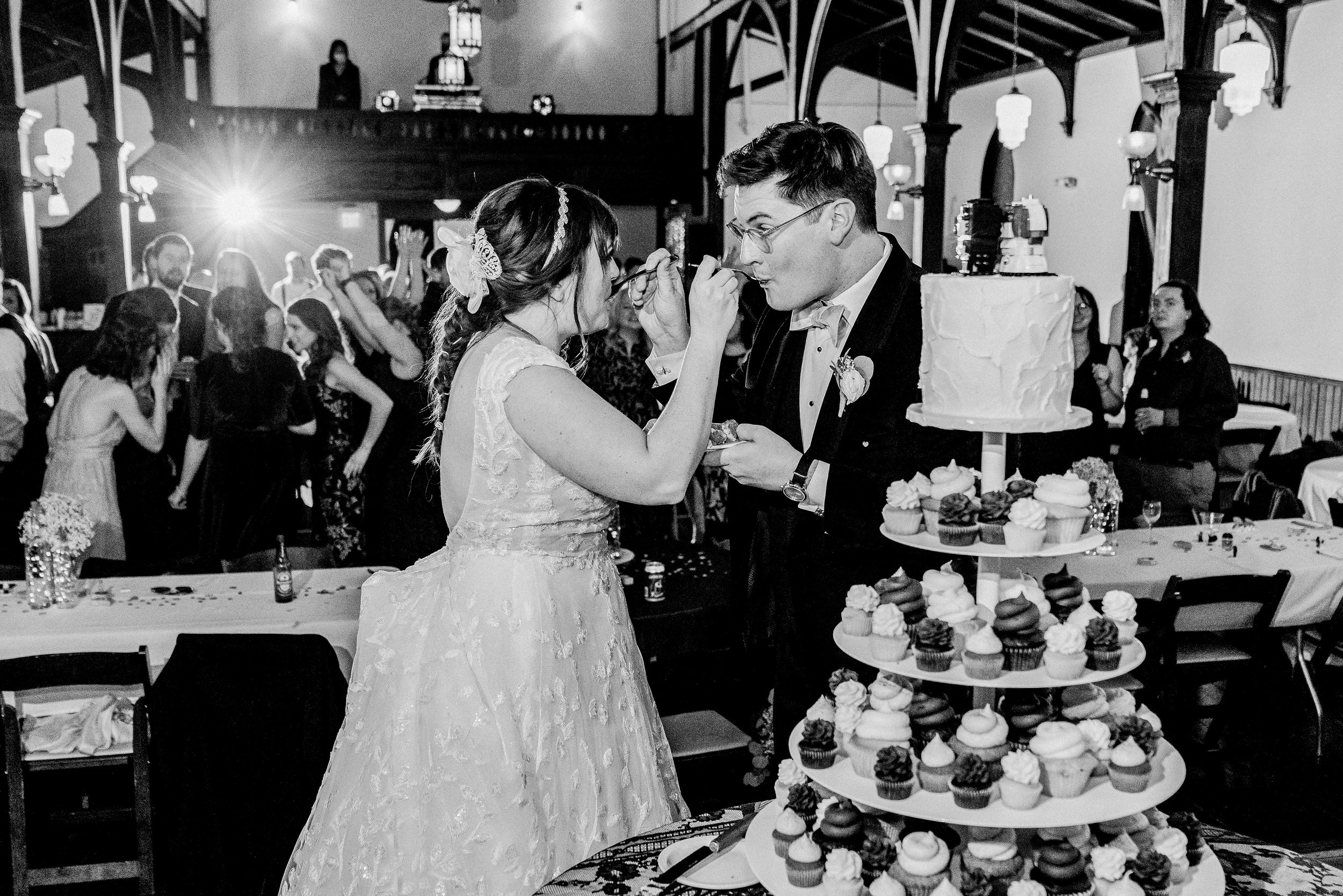 Bride and Groom Eat Cake Wedding at All Saints Chapel Raleigh NC Fancy This Photography
