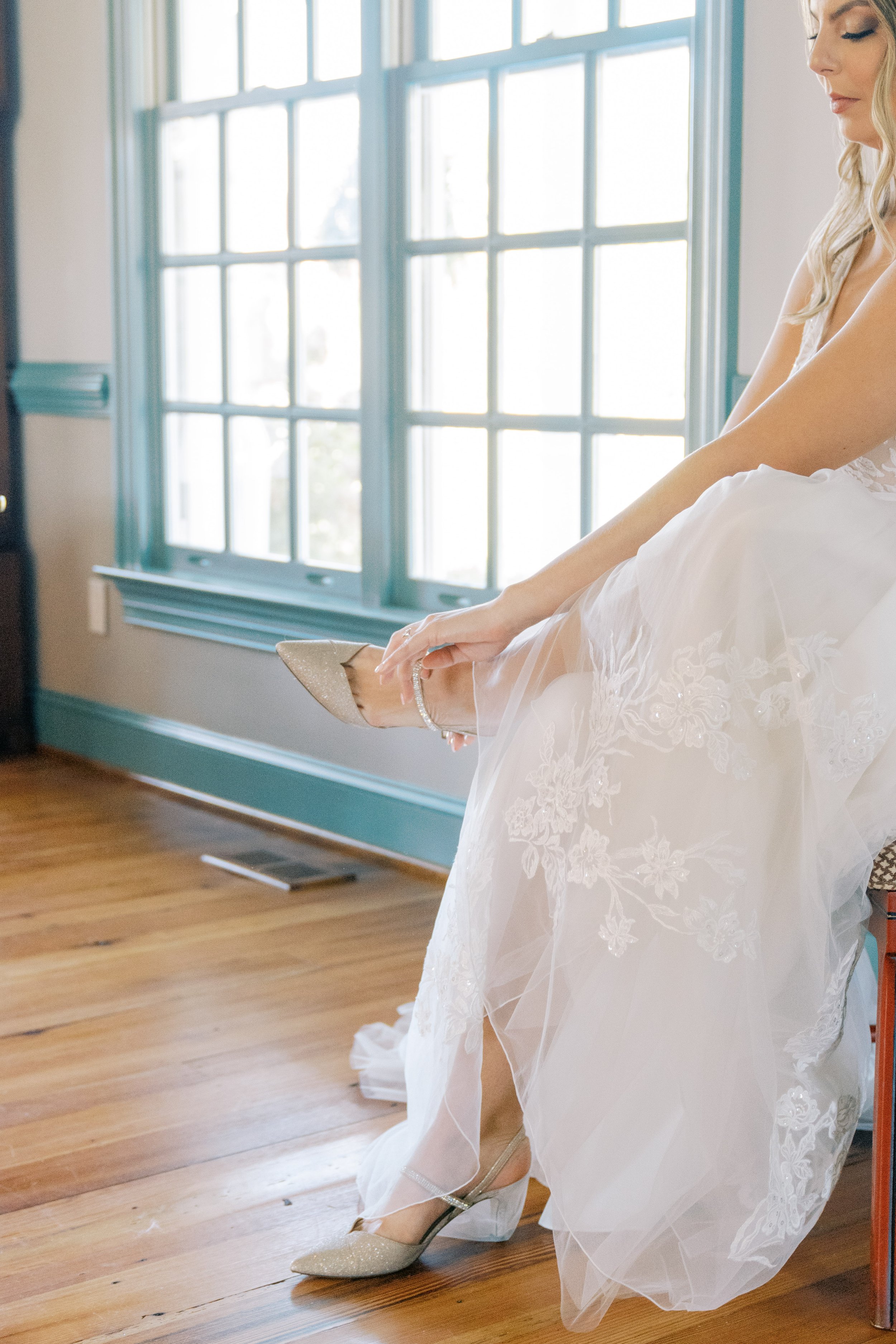 Bride Puts on Shoes Raleigh Event Space Walnut Hill Wedding Venue Fancy This Photography