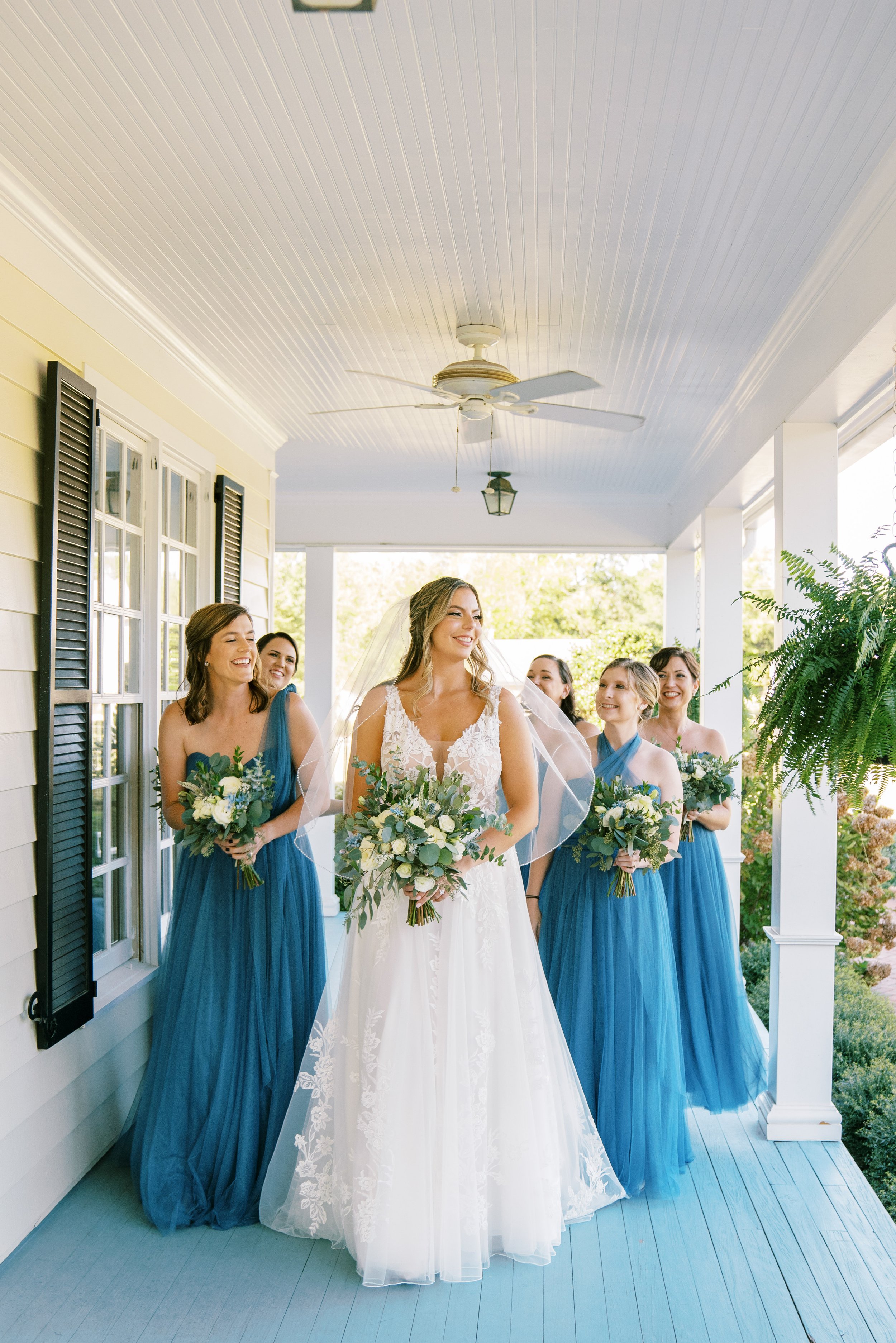 Bride and Blue Bridesmaids Front Porch Raleigh Event Space Walnut Hill Wedding Venue Fancy This Photography