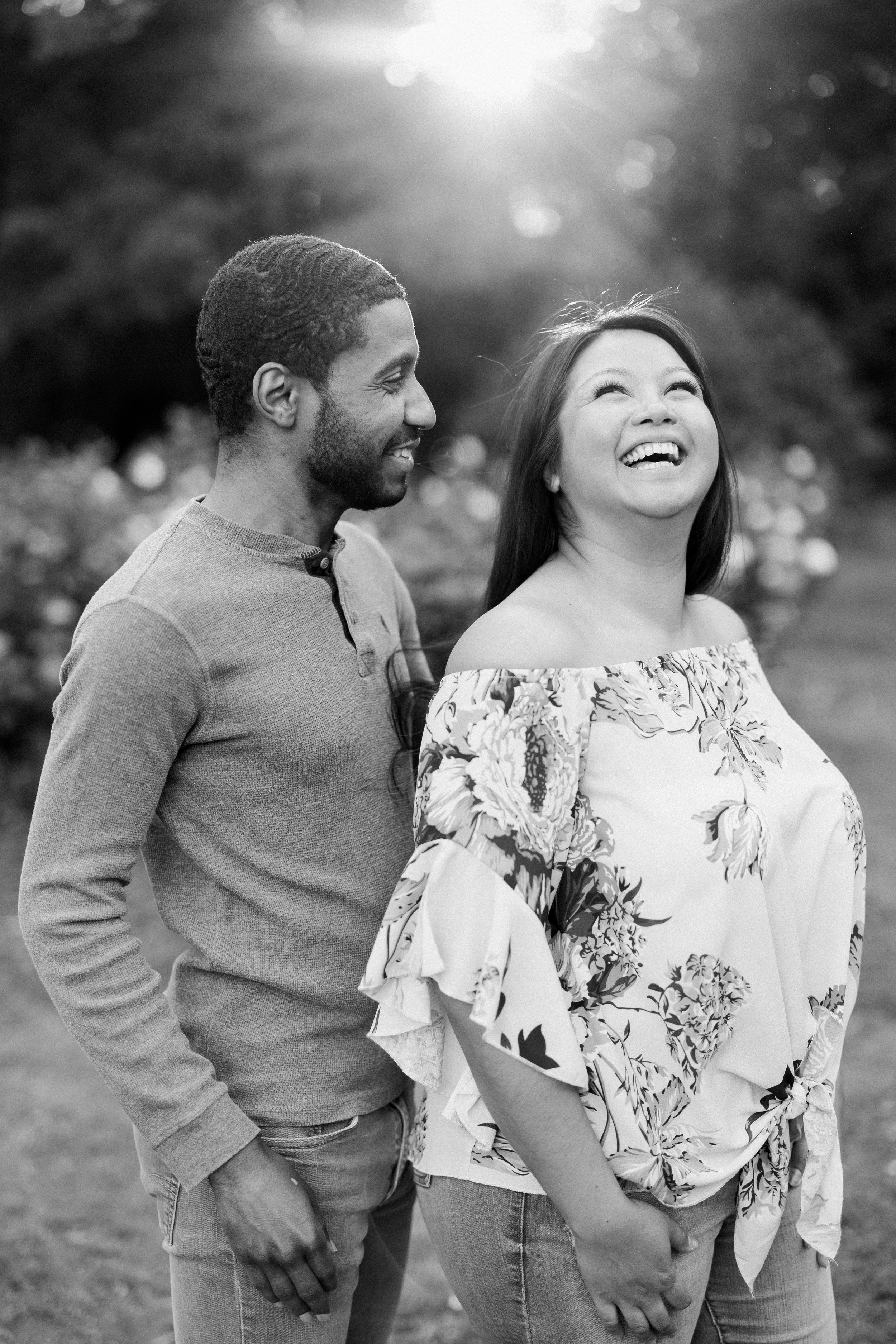 Black and White Laughter Engagement Photos in The Raleigh Rose Garden Fancy This Photography