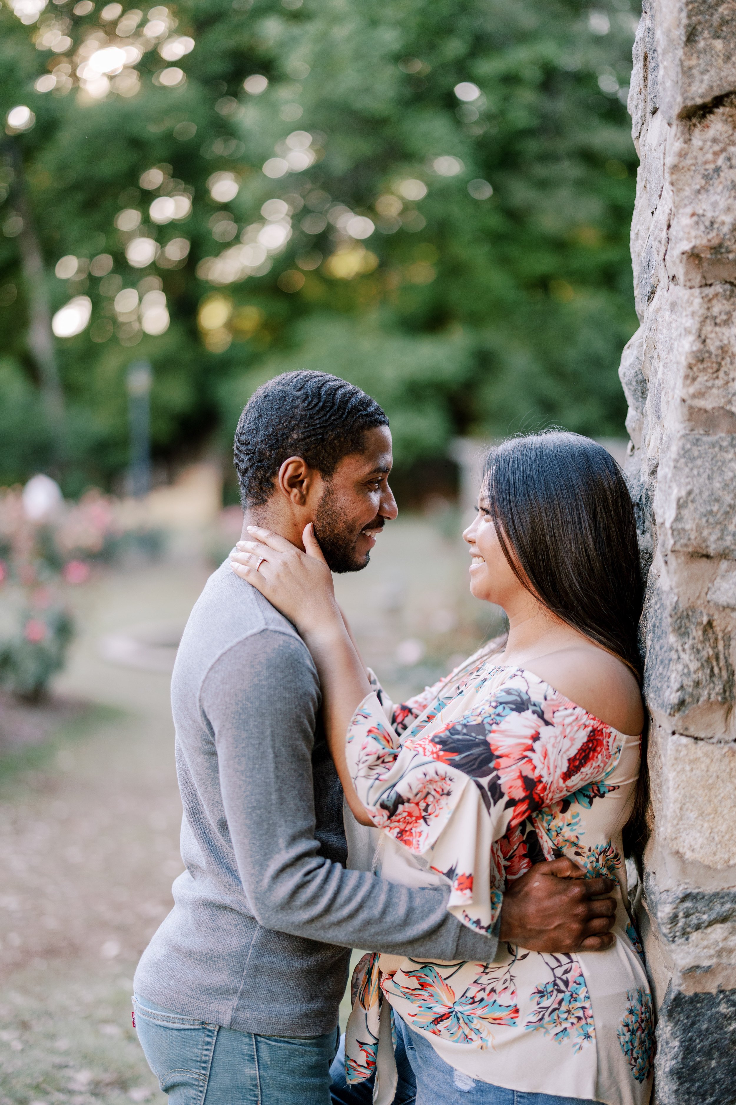 Couple Leans on Rose Garden Wall Engagement Photos in The Raleigh Rose Garden Fancy This Photography