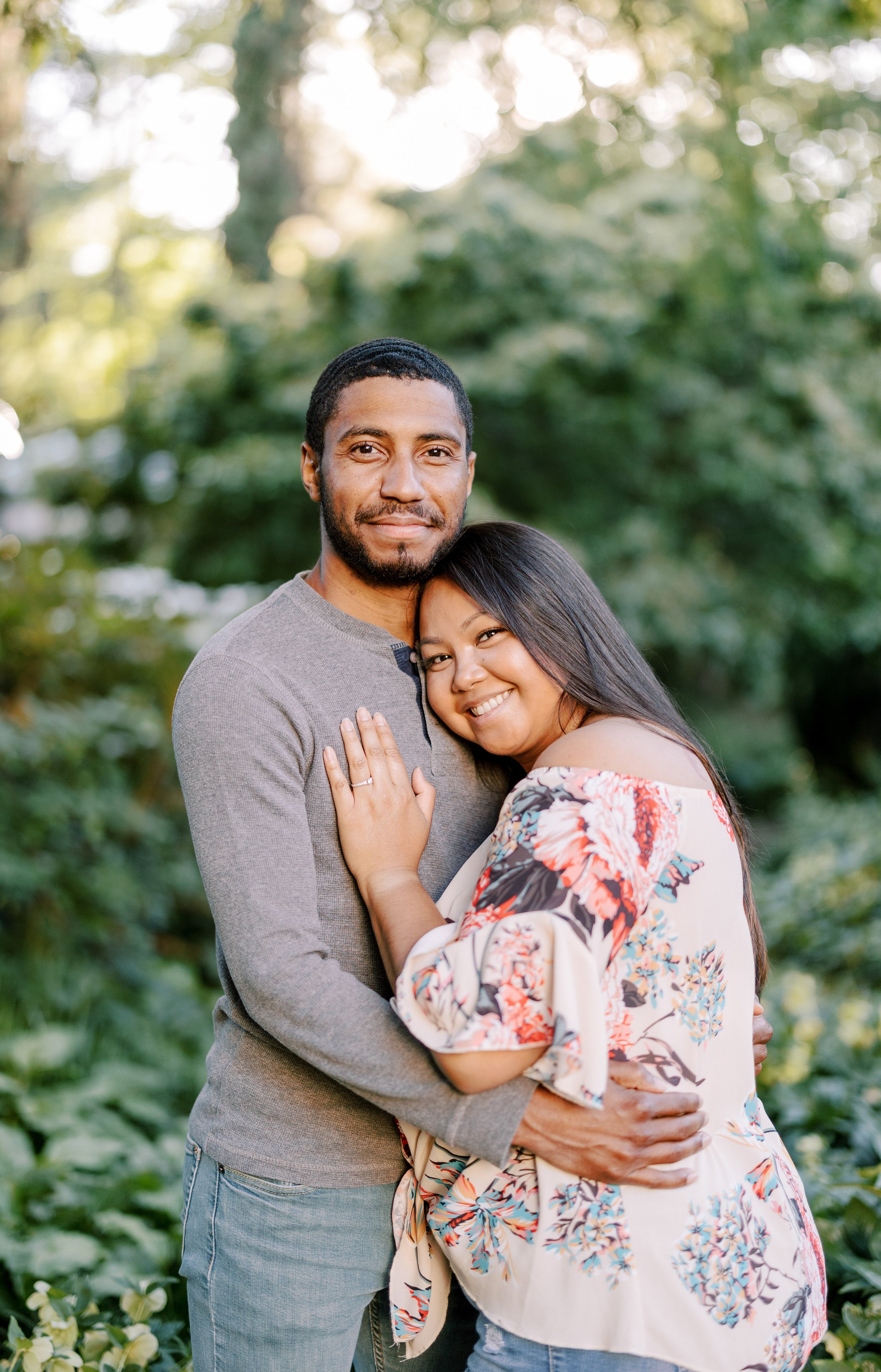 Couple in Green Forest Engagement Photos in The Raleigh Rose Garden Fancy This Photography
