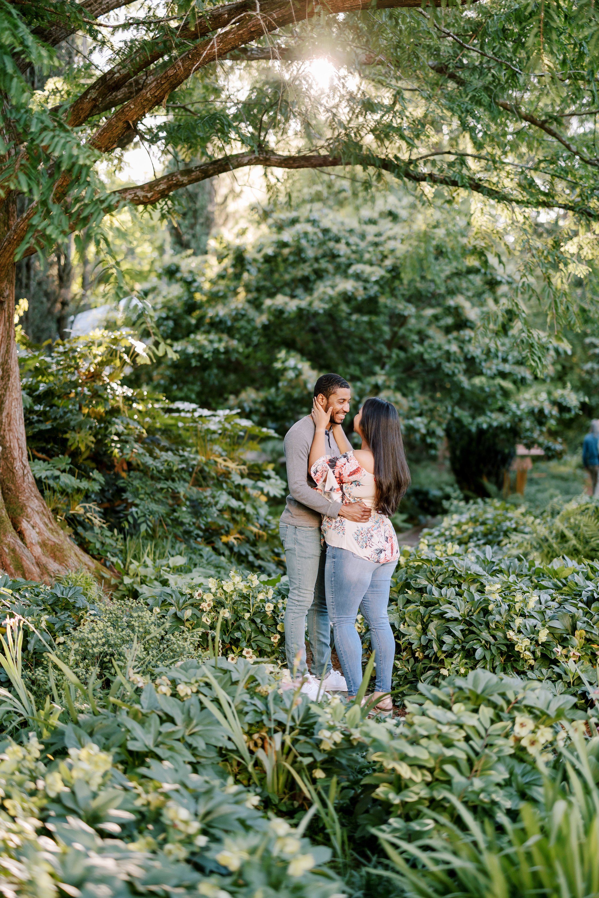 Couple in Forest Greenery Engagement Photos in The Raleigh Rose Garden Fancy This Photography