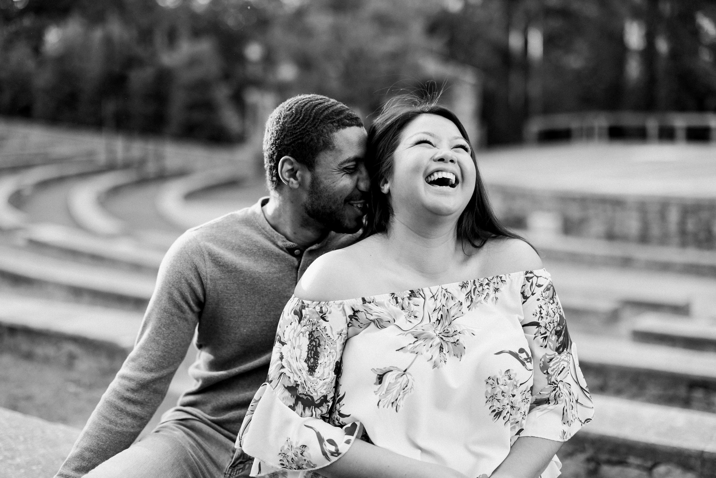 Black and White Laughing Couple Engagement Photos in The Raleigh Rose Garden Fancy This Photography