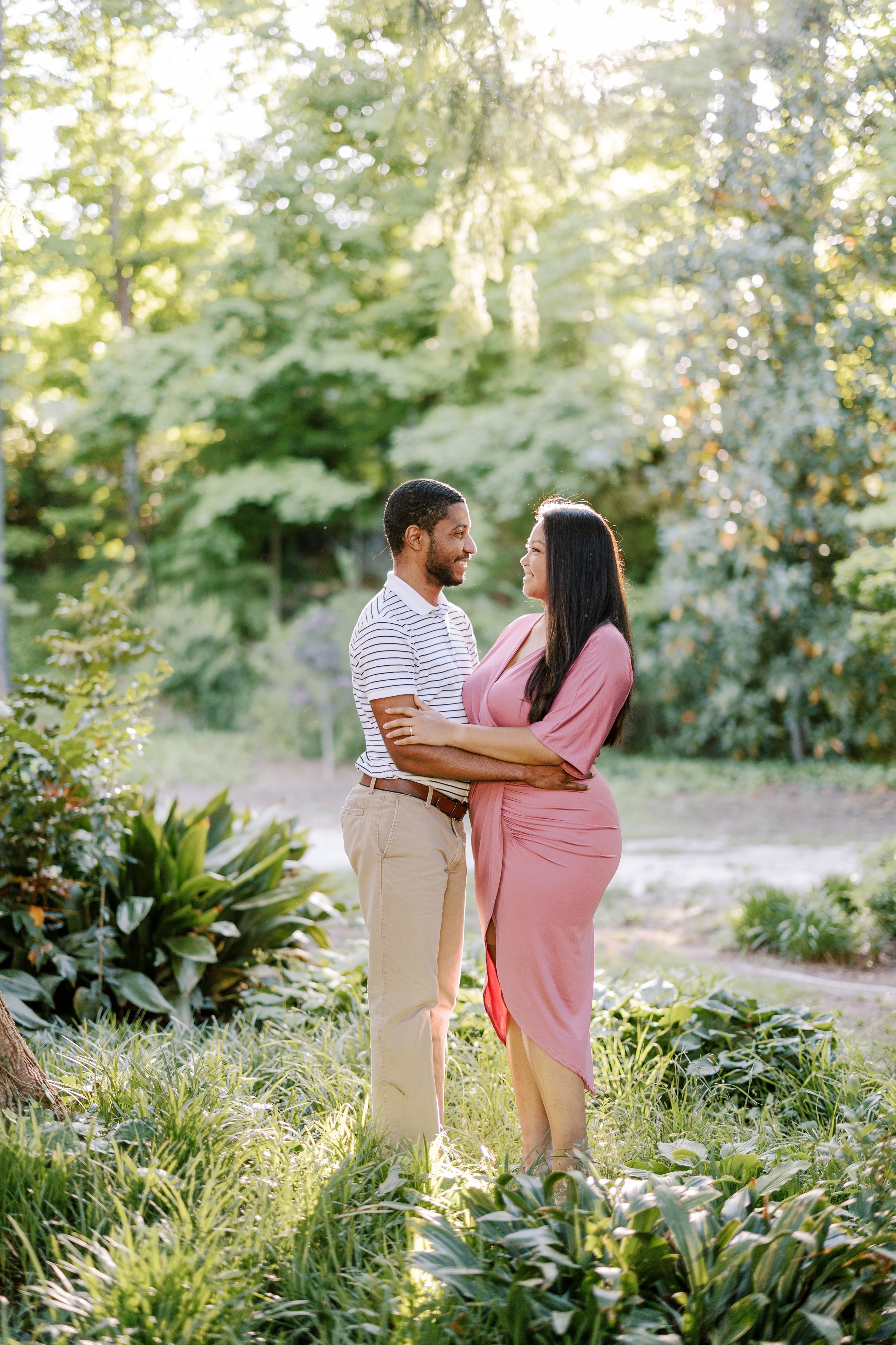 Colorful Image Kisses Engagement Photos in The Raleigh Rose Garden Fancy This Photography