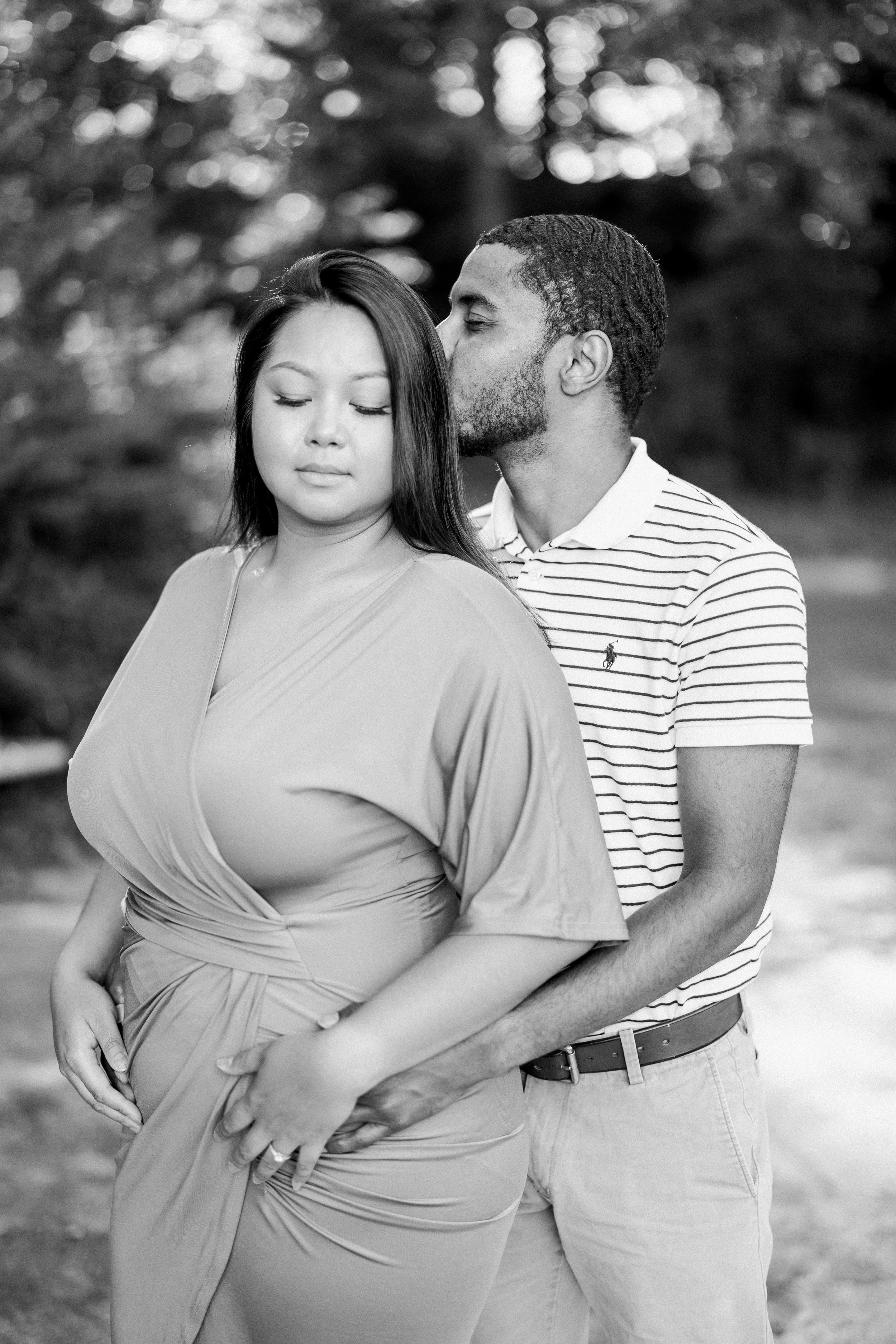 Black and White Image Kisses Engagement Photos in The Raleigh Rose Garden Fancy This Photography