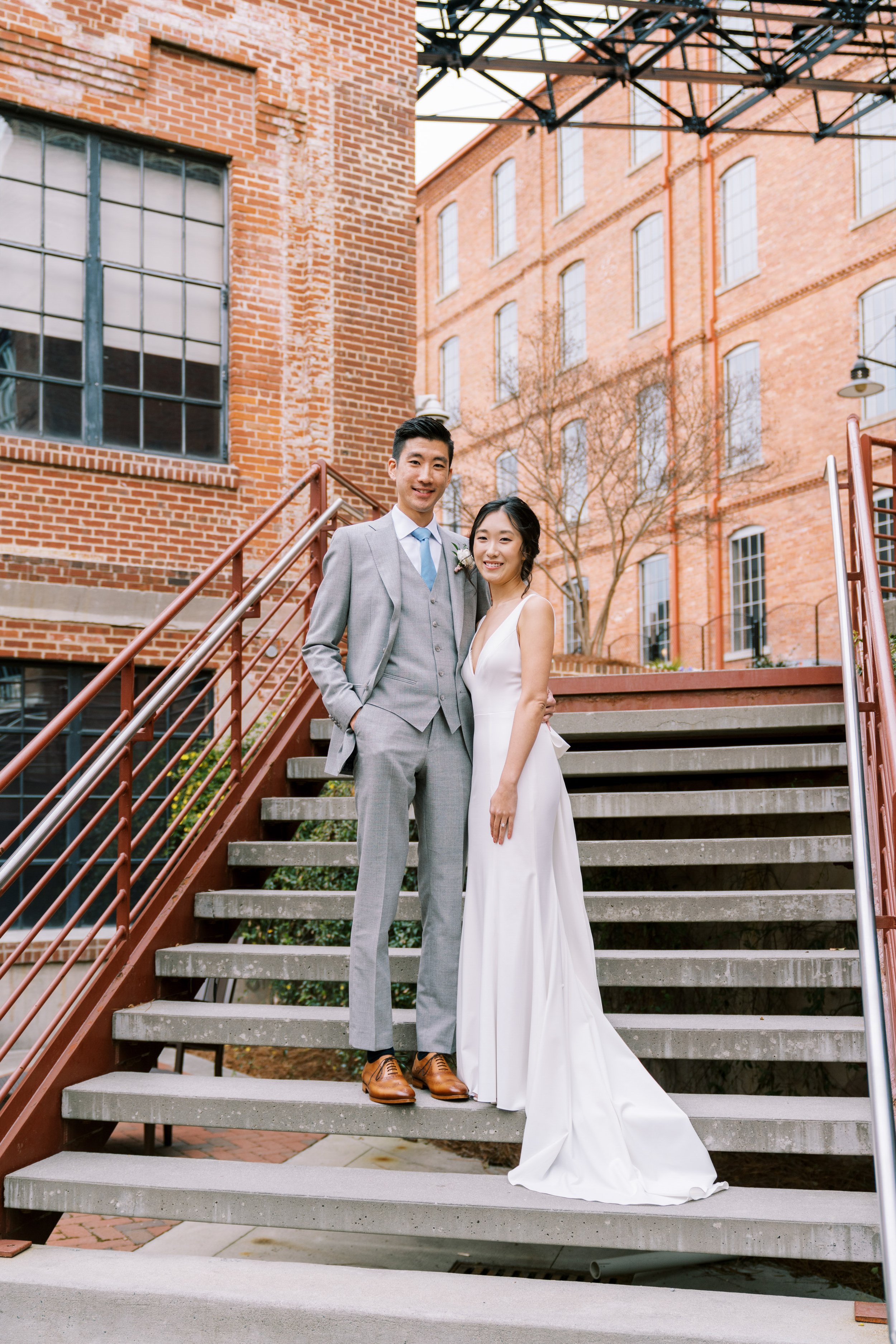 Bride and Groom on Staircase American Tobacco Campus Korean Wedding at Bay 7 Durham NC Fancy This Photography