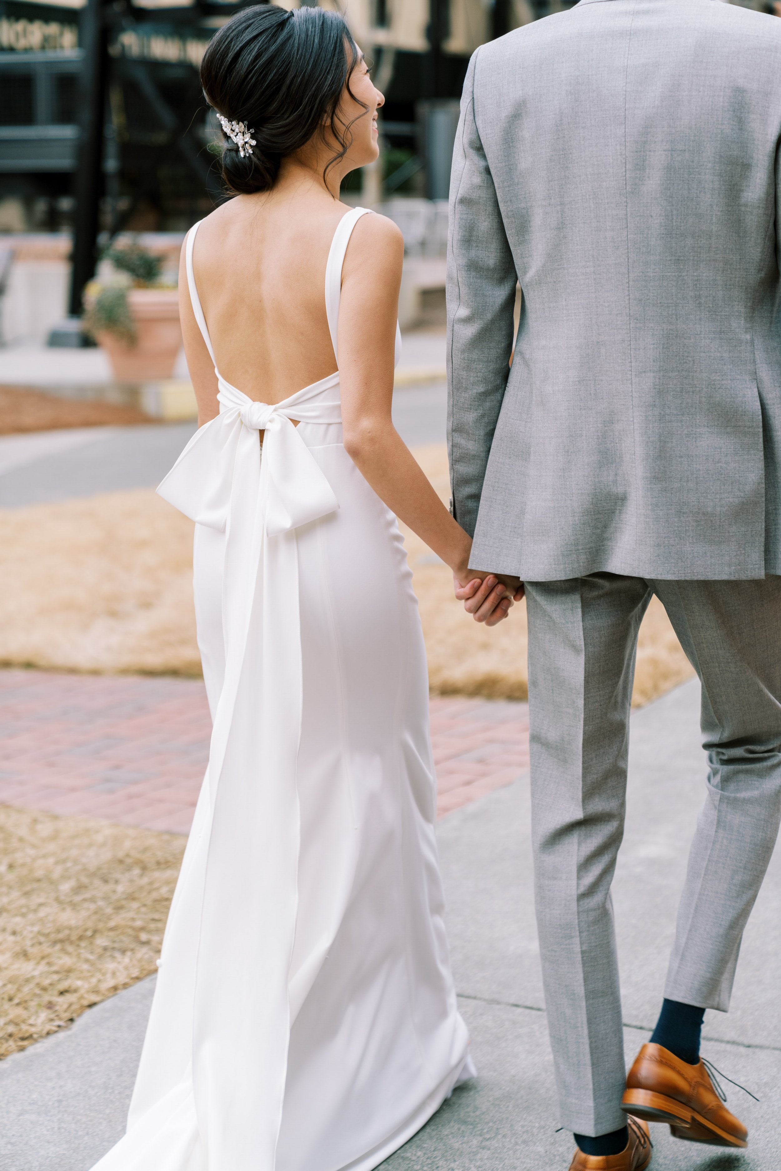 Wedding Dress with Bow Bride and Groom American Tobacco Campus Wedding at Bay 7 Durham NC Fancy This Photography