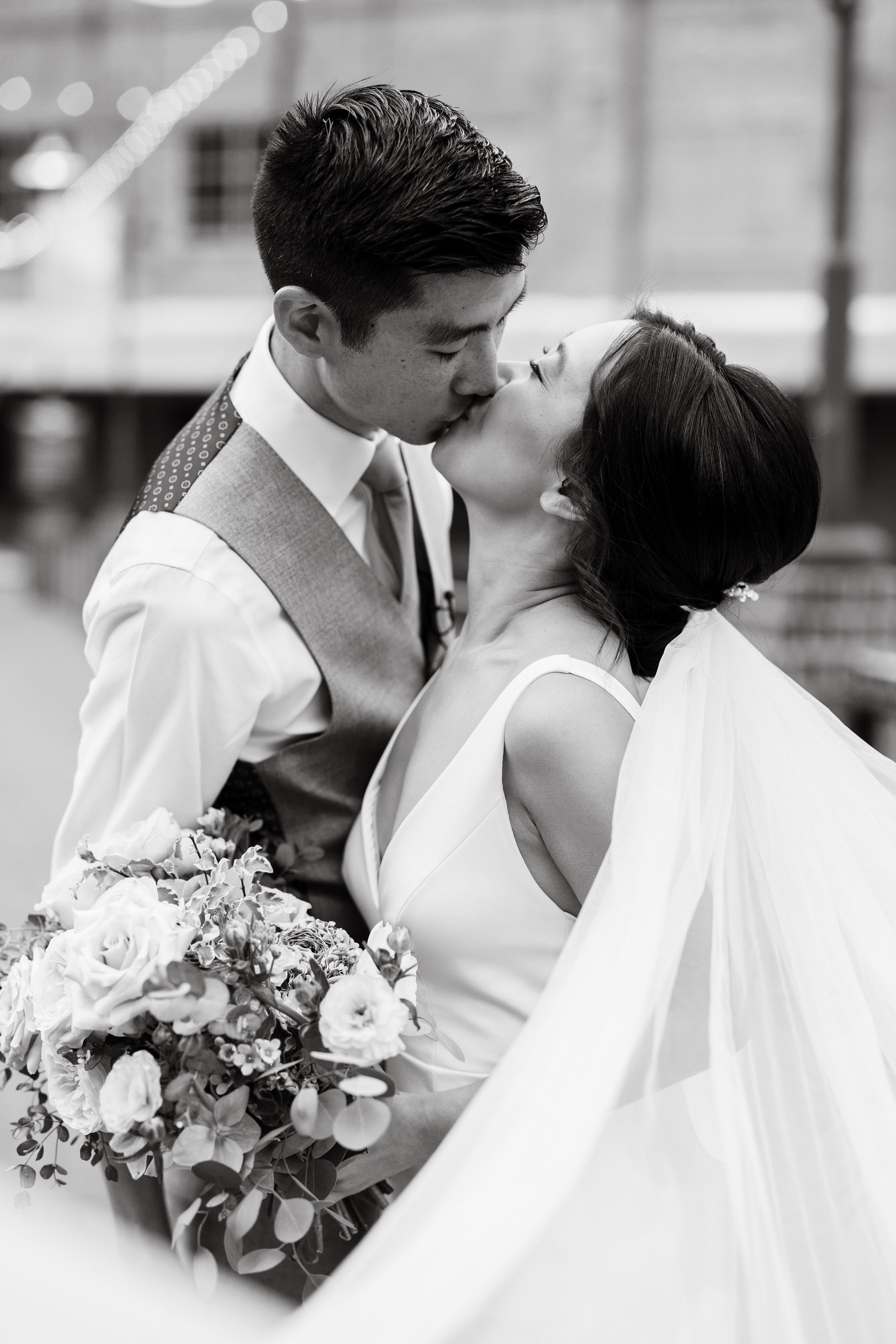 Dramatic Fine Art Bride and Groom Kiss American Tobacco Campus Wedding at Bay 7 Durham NC Fancy This Photography