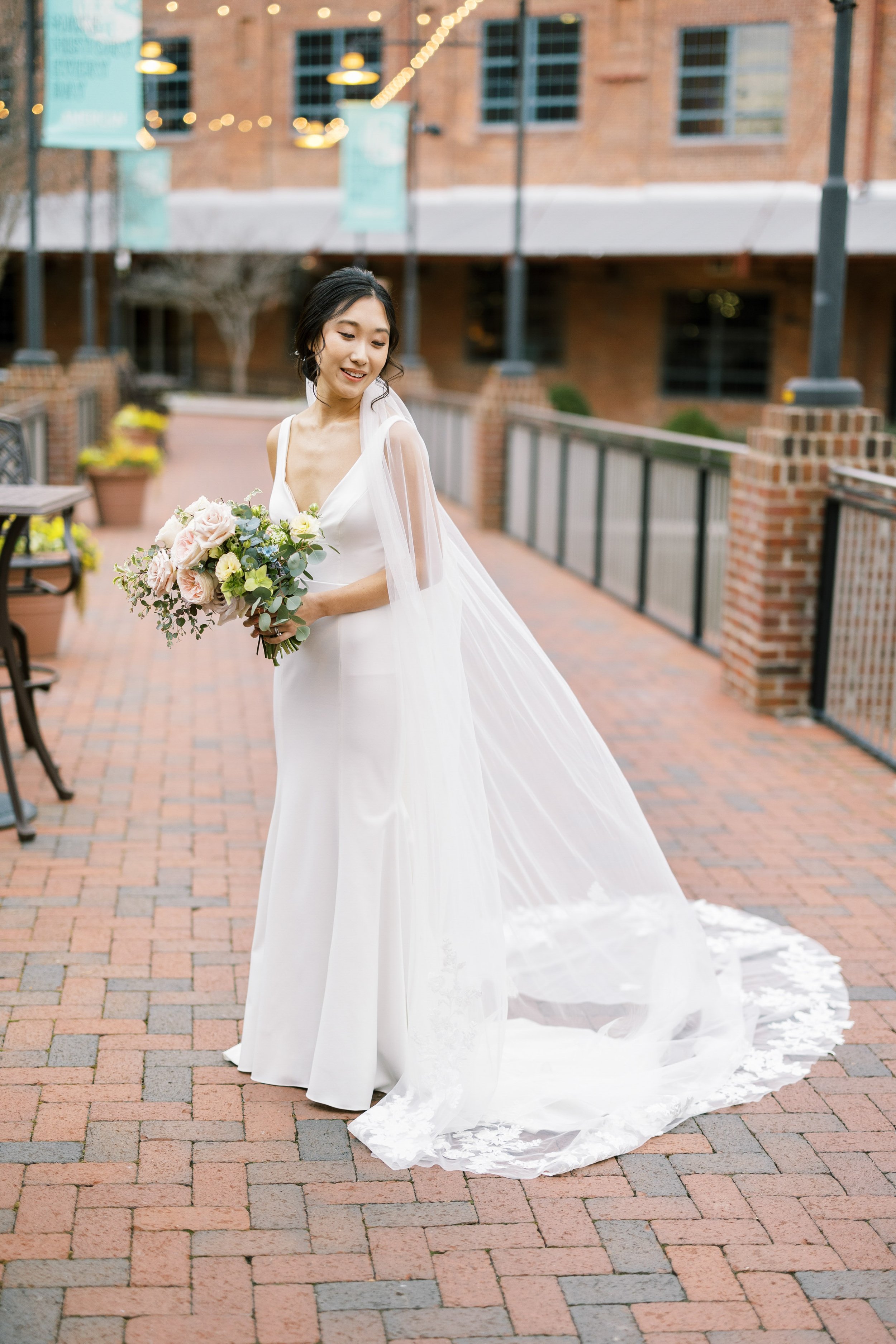 Bride on Brick Bridge American Tobacco Campus Wedding at Bay 7 Durham NC Fancy This Photography